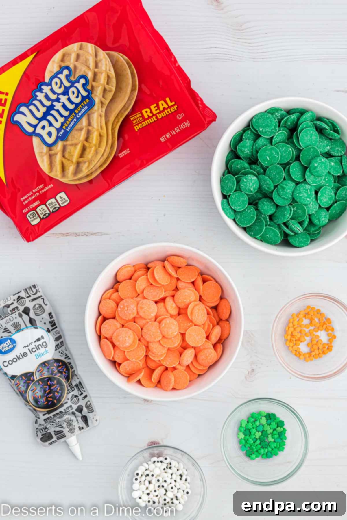 Lucky Leprechaun Bites 3 All the necessary ingredients for making Leprechaun cookies, including Nutter Butter cookies, various candy melts, decorating icing, and sprinkles, neatly arranged.