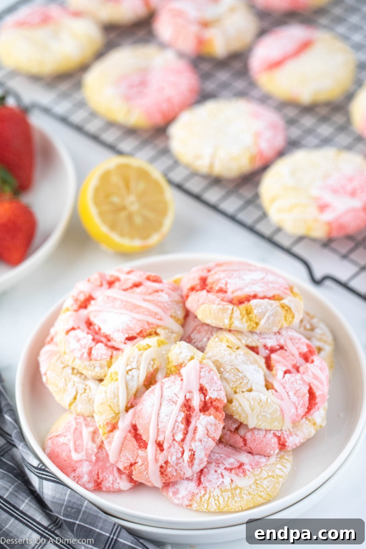 Tangy Strawberry Lemonade Cookies 2 Freshly baked Strawberry Lemonade Cookies arranged beautifully on a platter, showcasing their vibrant colors and luscious glaze.
