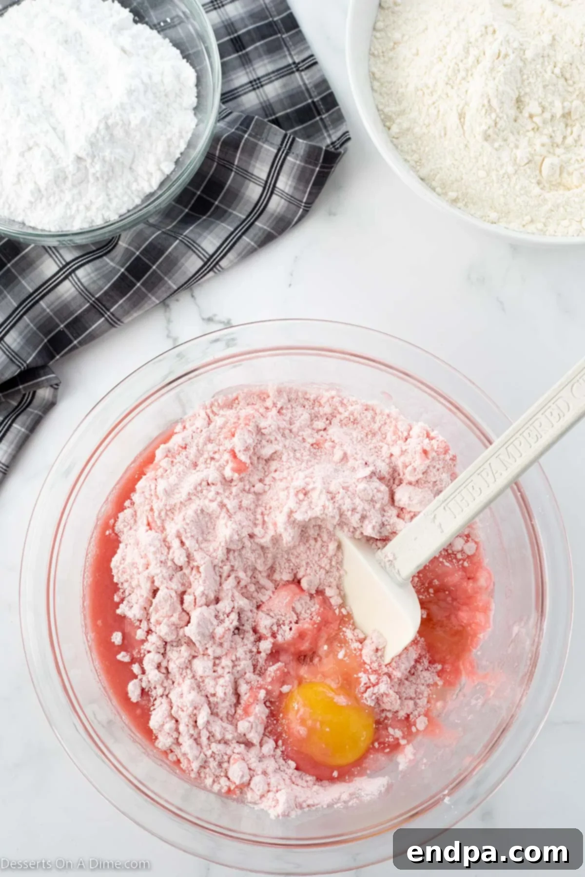 Tangy Strawberry Lemonade Cookies 4 Strawberry cake mix being combined with wet ingredients in a mixing bowl to form the dough.