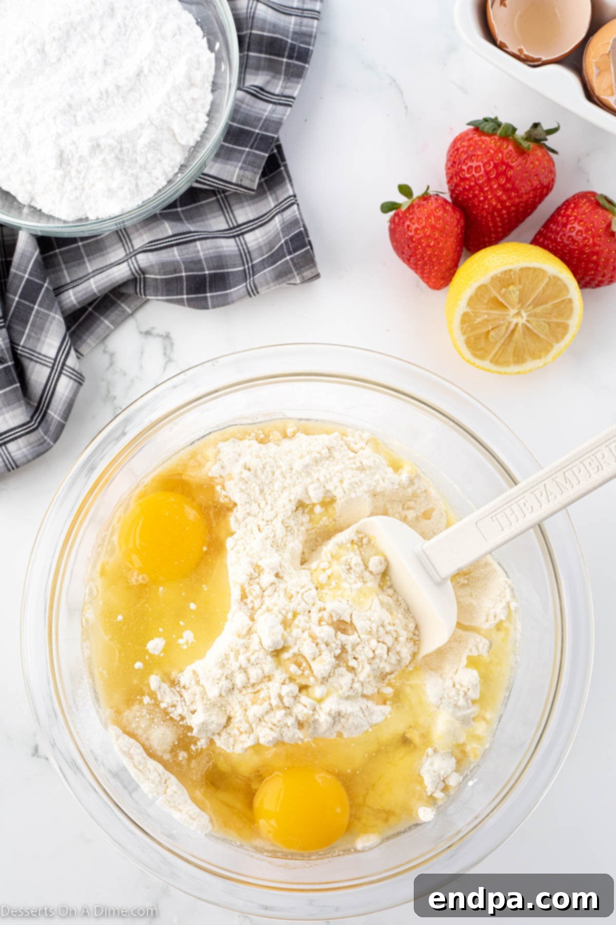 Tangy Strawberry Lemonade Cookies 5 Lemon cake mix being combined with wet ingredients in a separate mixing bowl to form the dough.