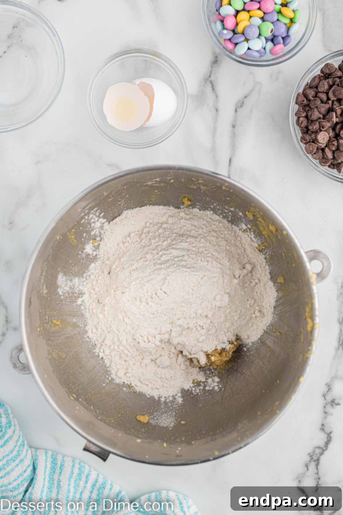 Dry ingredients - flour, baking soda, and salt - being added to the wet mixture