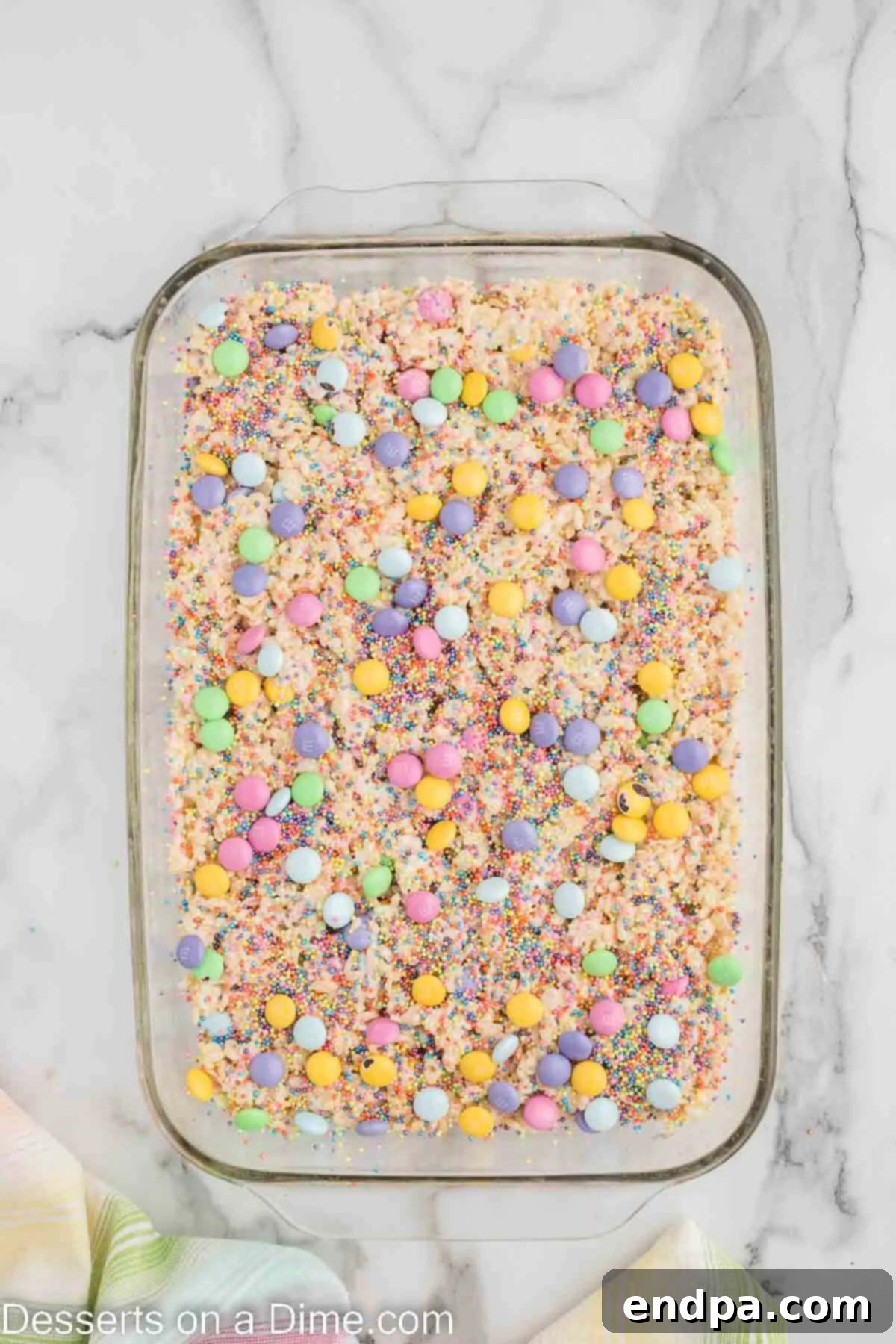 Springtime Krispie Delights 7 Candy and sprinkles scattered on top of the Rice Krispie Treats.