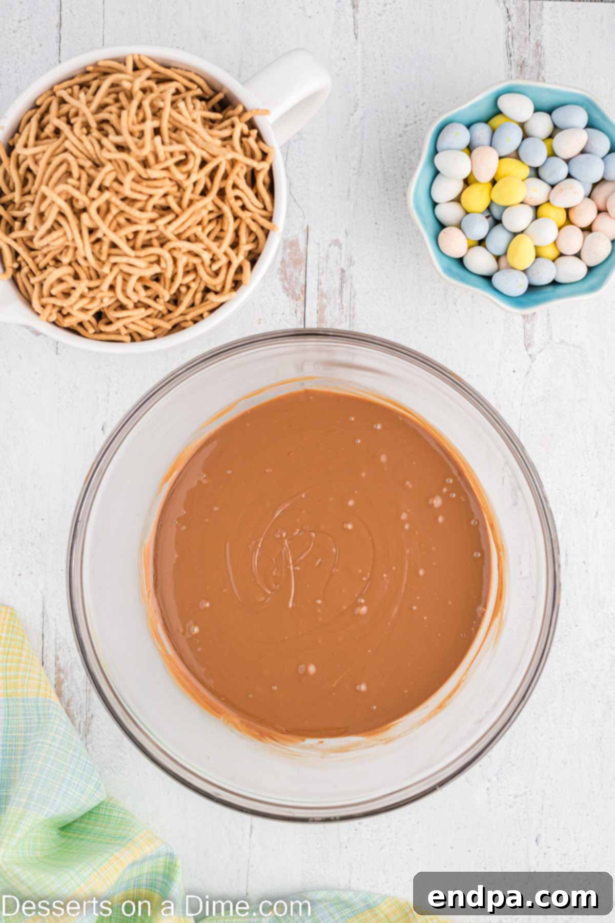Melted chocolate, butterscotch, and peanut butter in a microwave-safe bowl.