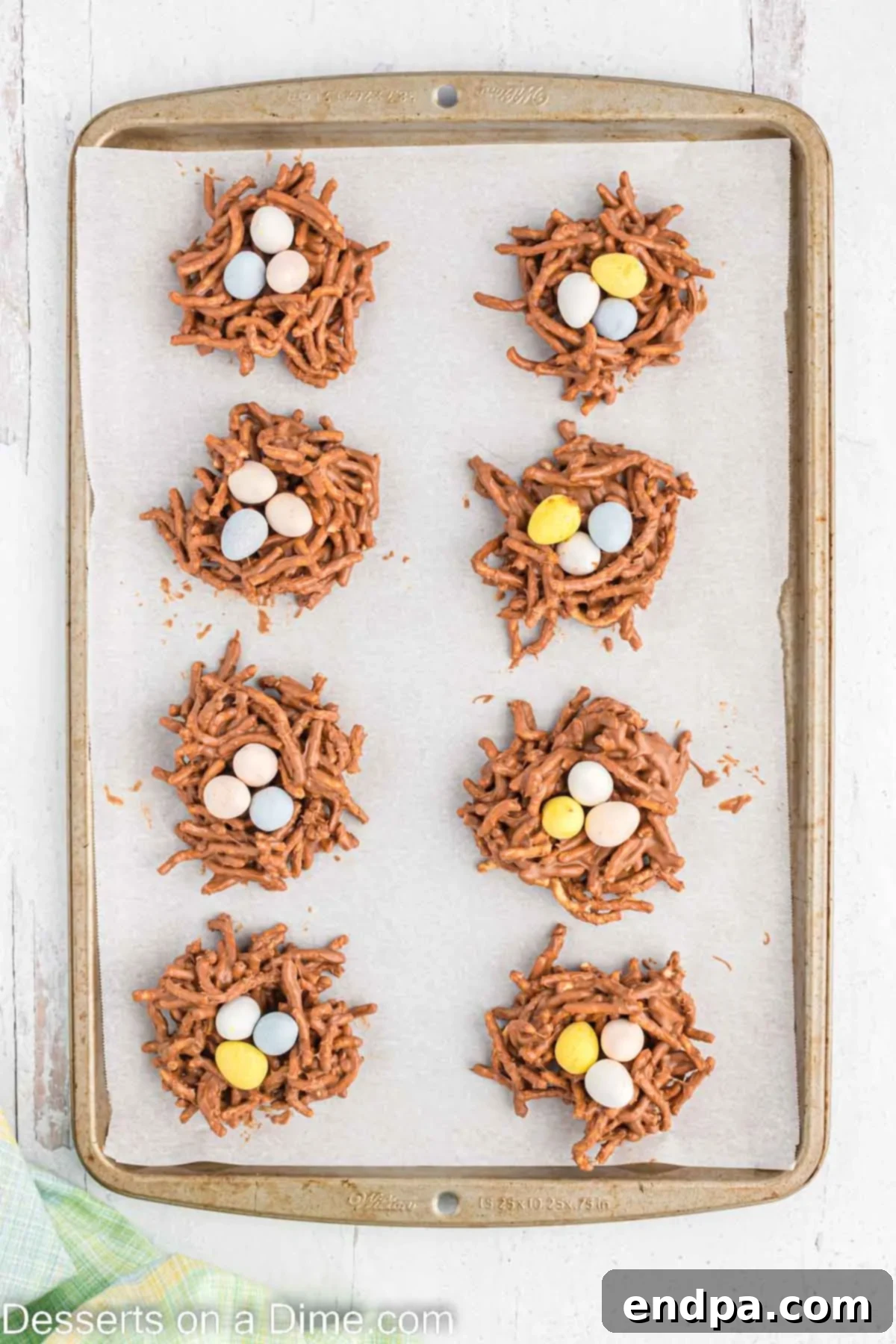 Birds nest cookies formed and placed on a baking sheet lined with parchment paper.