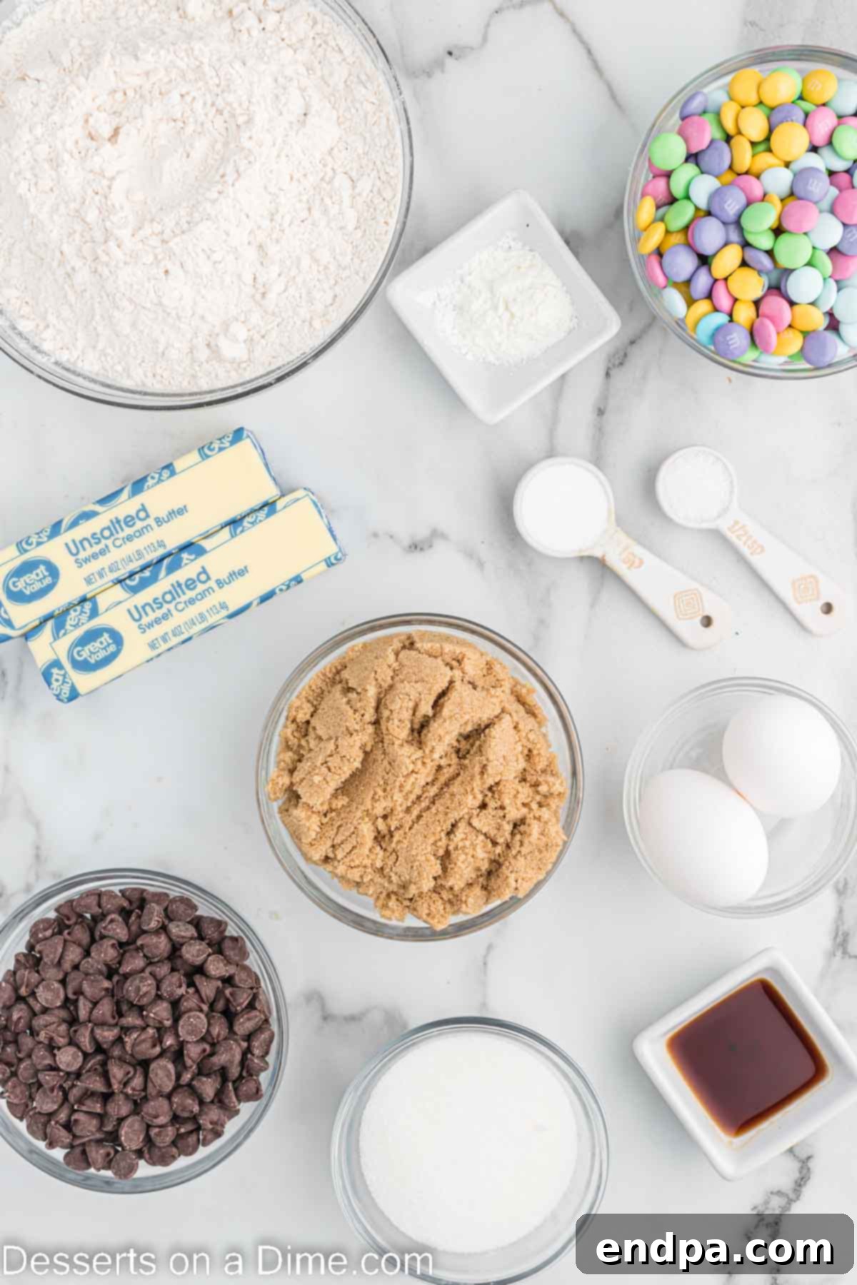 Hoppy Easter Chocolate Chip Cookies 3 A vibrant flat lay of all the essential ingredients needed for Easter Chocolate Chip Cookies: softened butter, granulated sugar, rich brown sugar, fresh large eggs, aromatic vanilla extract, all-purpose flour, cornstarch, baking soda, a pinch of salt, semi-sweet chocolate chips, and a generous scattering of colorful Easter M&M's.