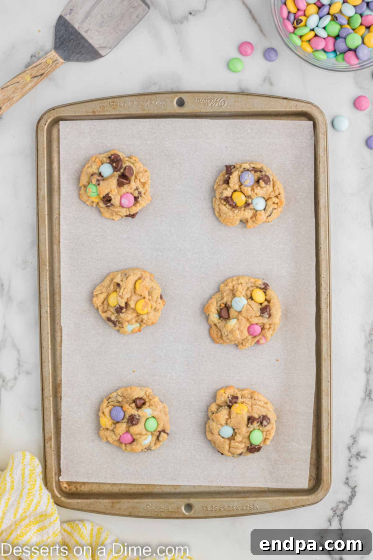 Hoppy Easter Chocolate Chip Cookies 8 Freshly baked Easter Chocolate Chip Cookies cooling on the baking sheet, showing slightly golden edges.