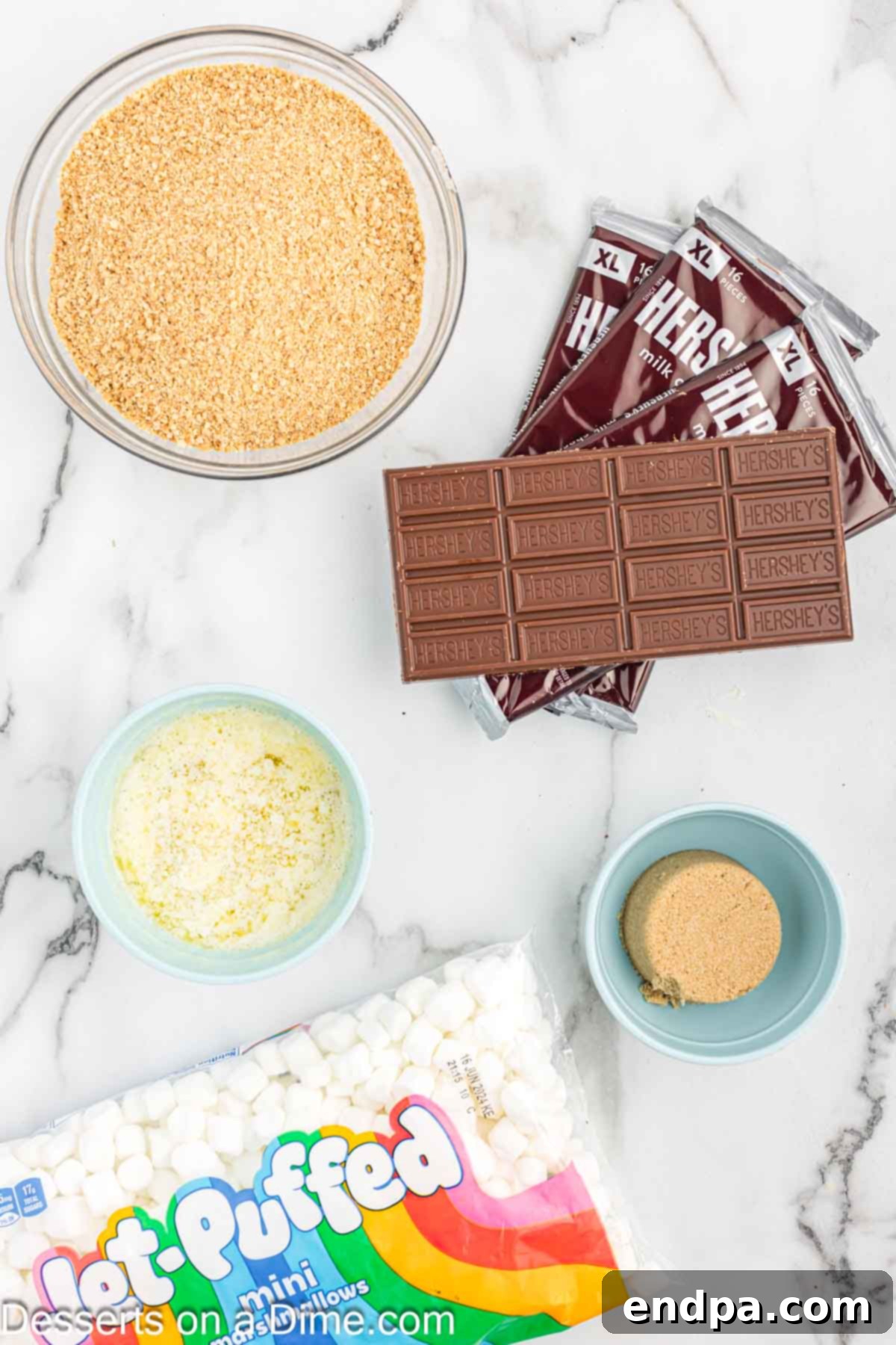 Gooey S'mores Delights 3 Ingredients for S'mores Bars recipe - graham cracker crumbs, marshmallows, brown sugar, butter, and chocolate bars laid out.