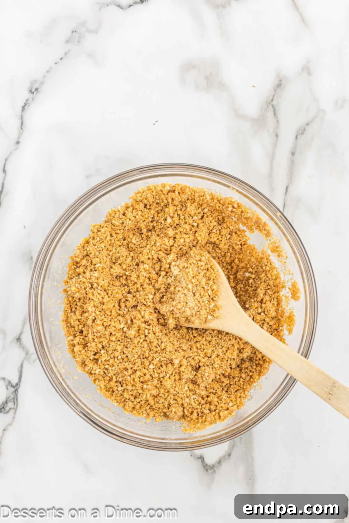 Gooey S'mores Delights 4 Bowl of graham cracker crumbs mixed with butter and brown sugar.