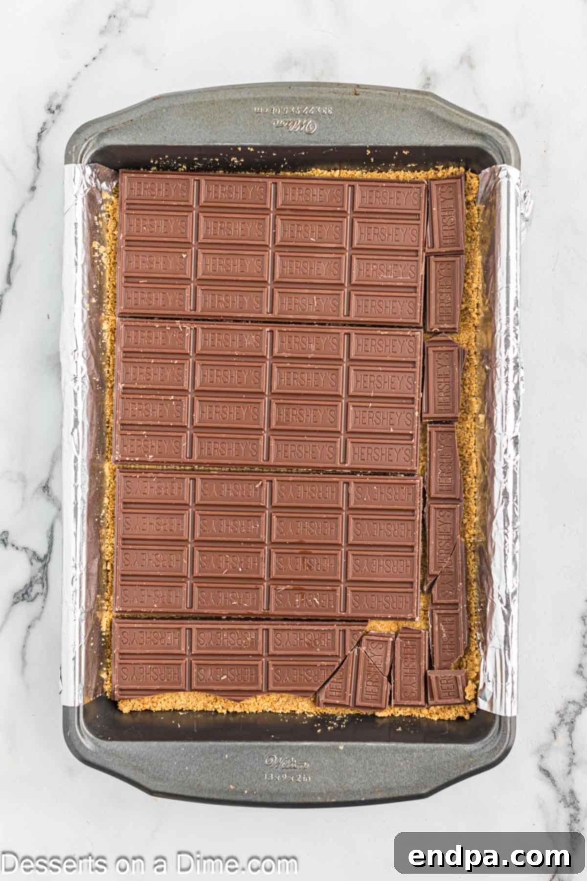 Gooey S'mores Delights 6 Hershey's chocolate bars placed on top of the cooled graham cracker crust.