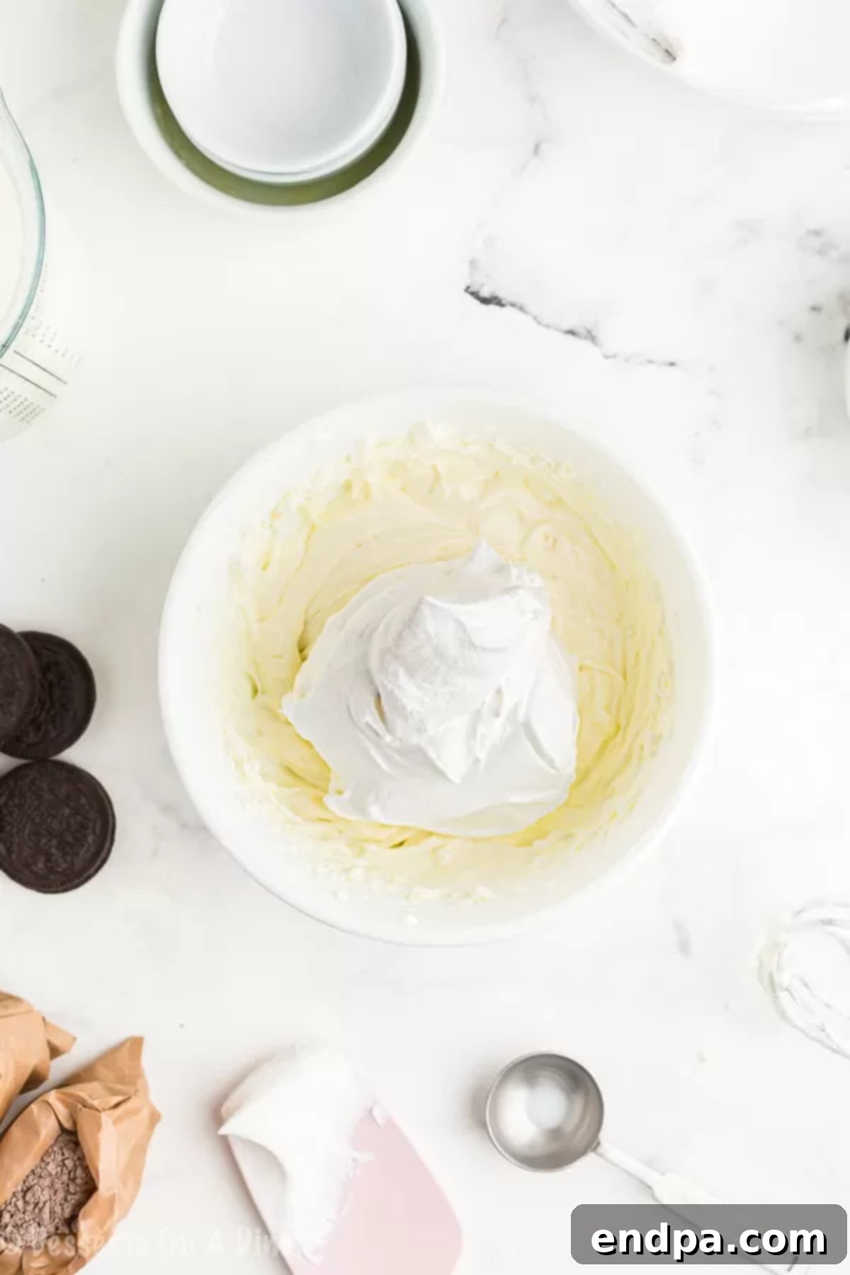 Cream cheese and pudding mixture combined in a bowl. 