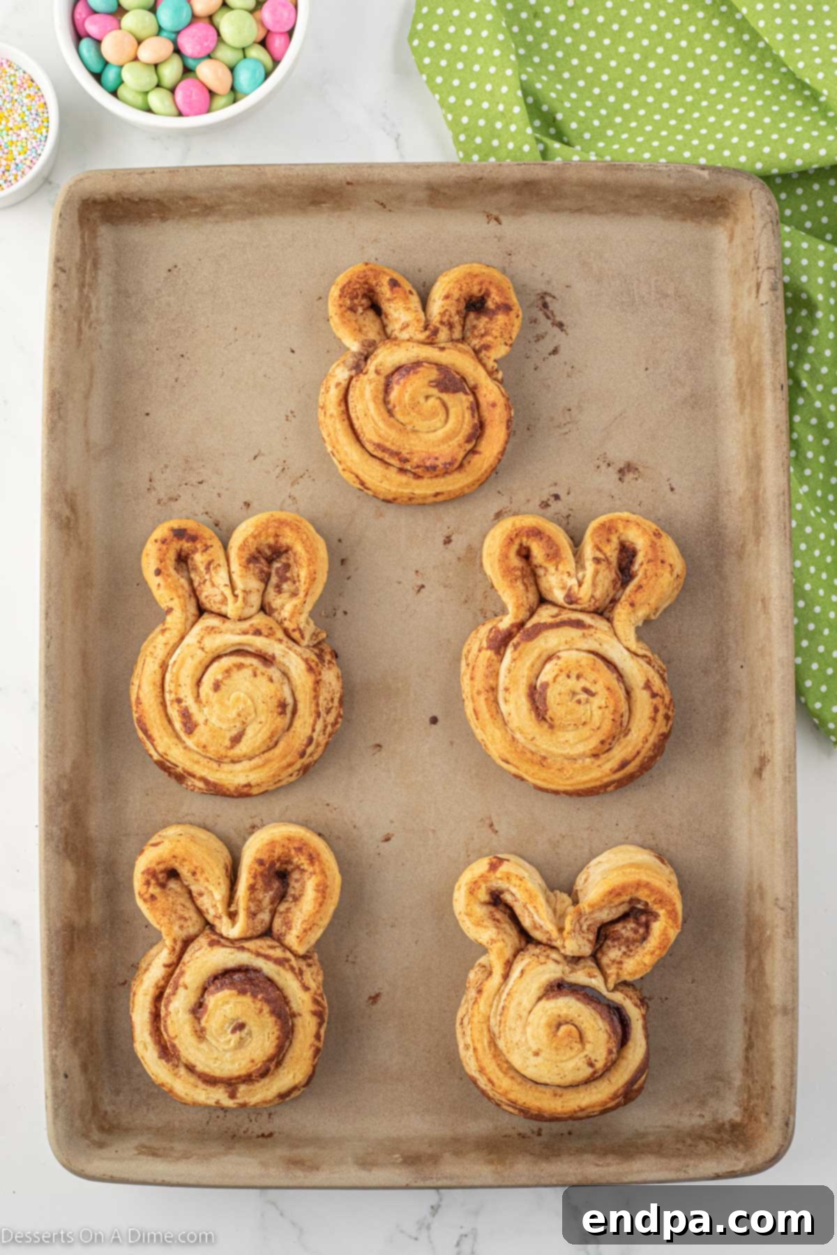 Baked cinnamon rolls cooling on a wire rack.