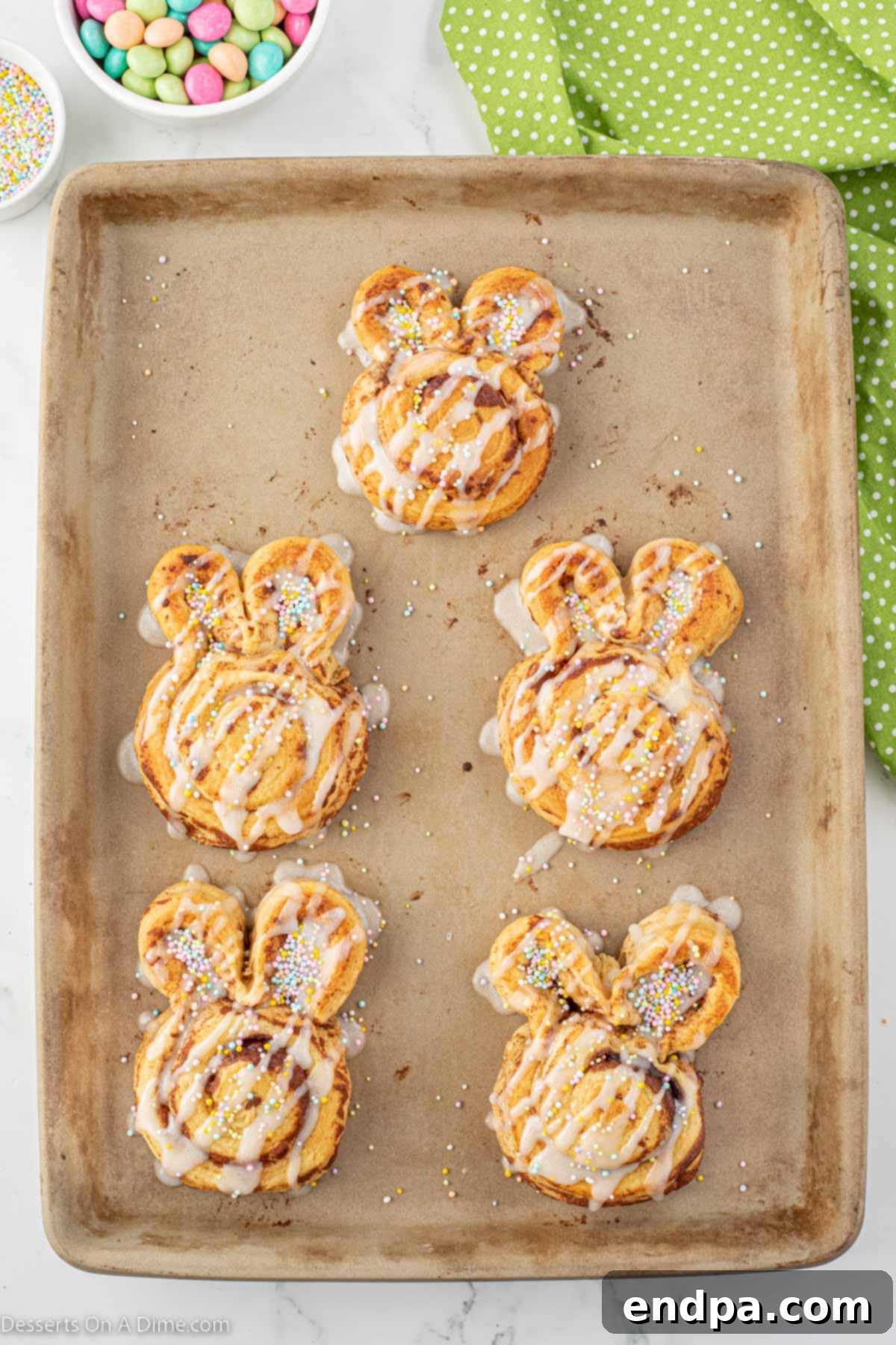 Icing drizzled over baked cinnamon rolls.