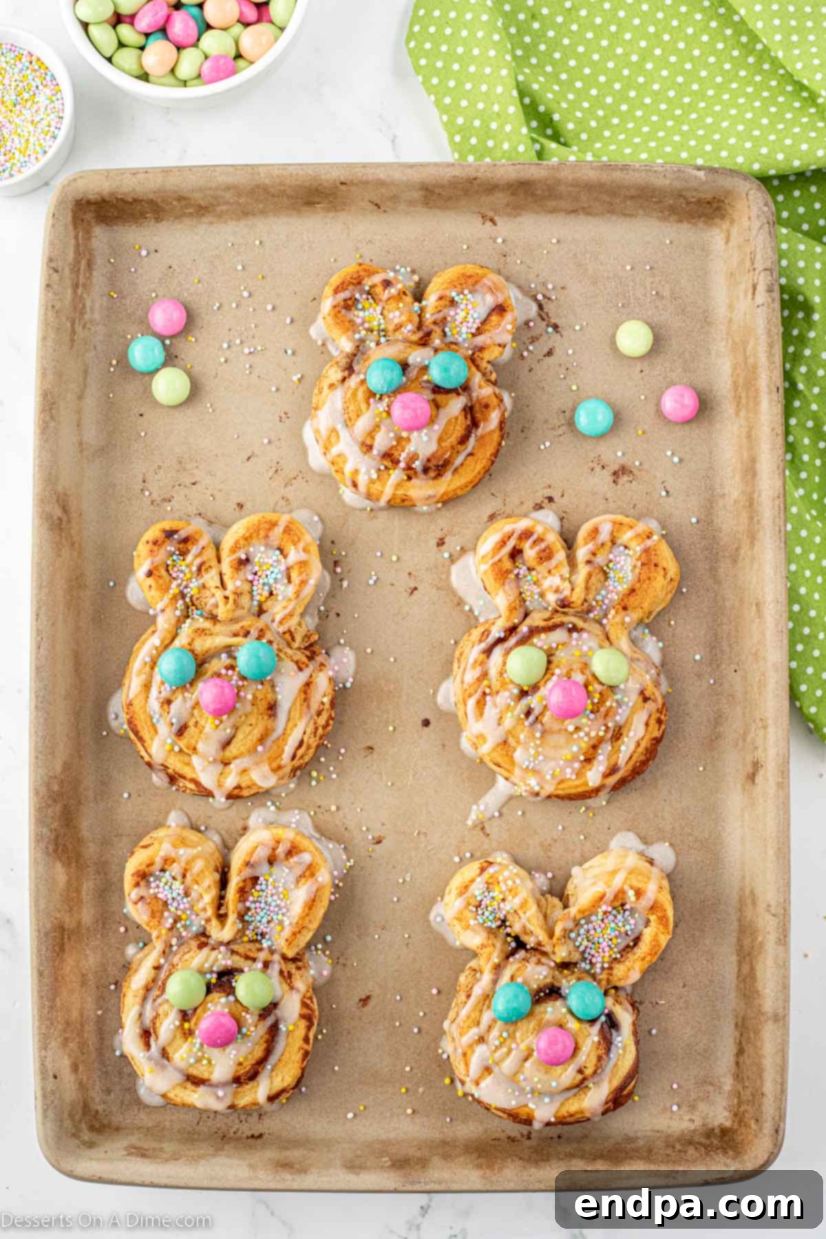 Sprinkles and M&Ms candy topped on each cinnamon roll to create the bunny face.