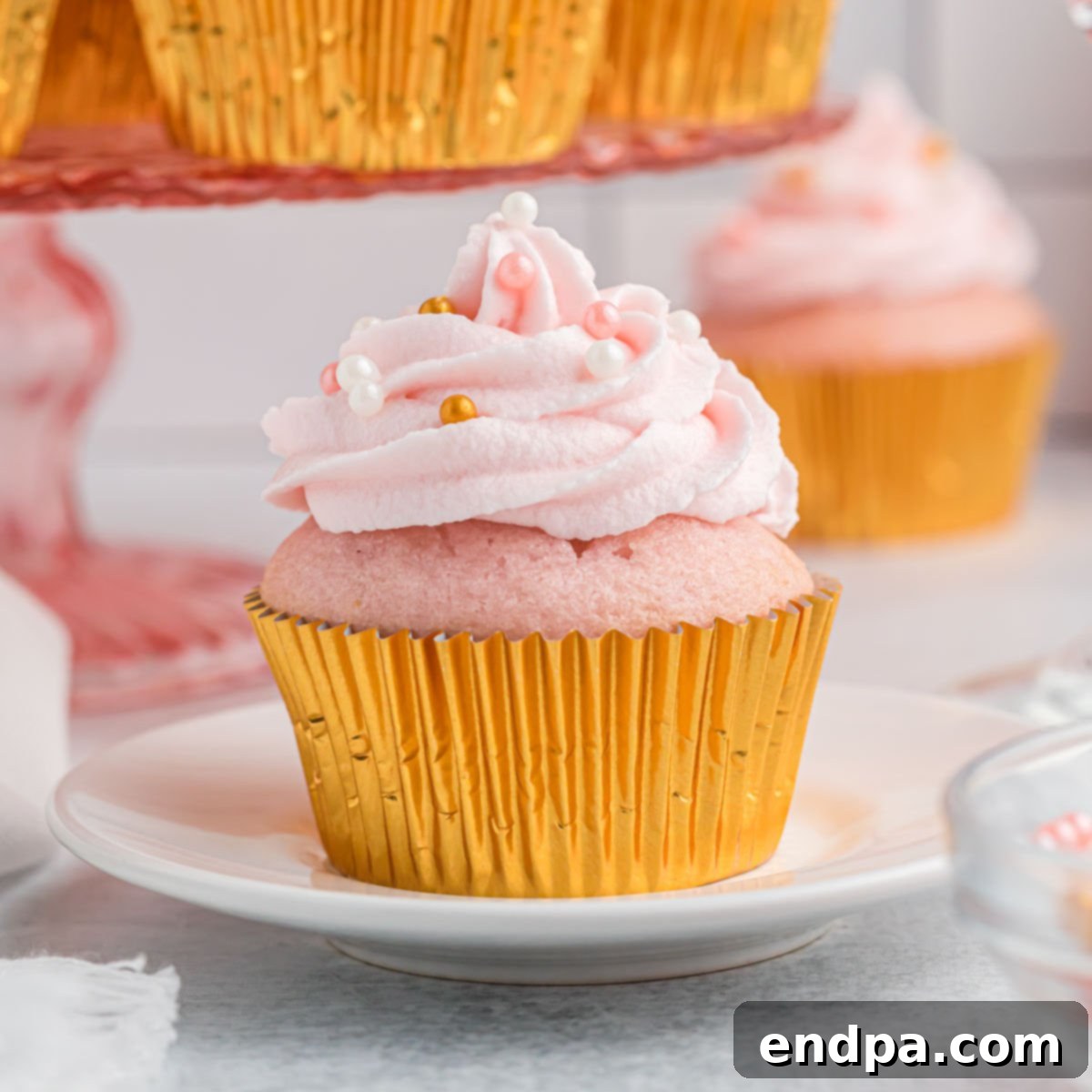 Beautifully frosted Pink Champagne Cupcakes, adorned with festive sprinkles, ready to be served.