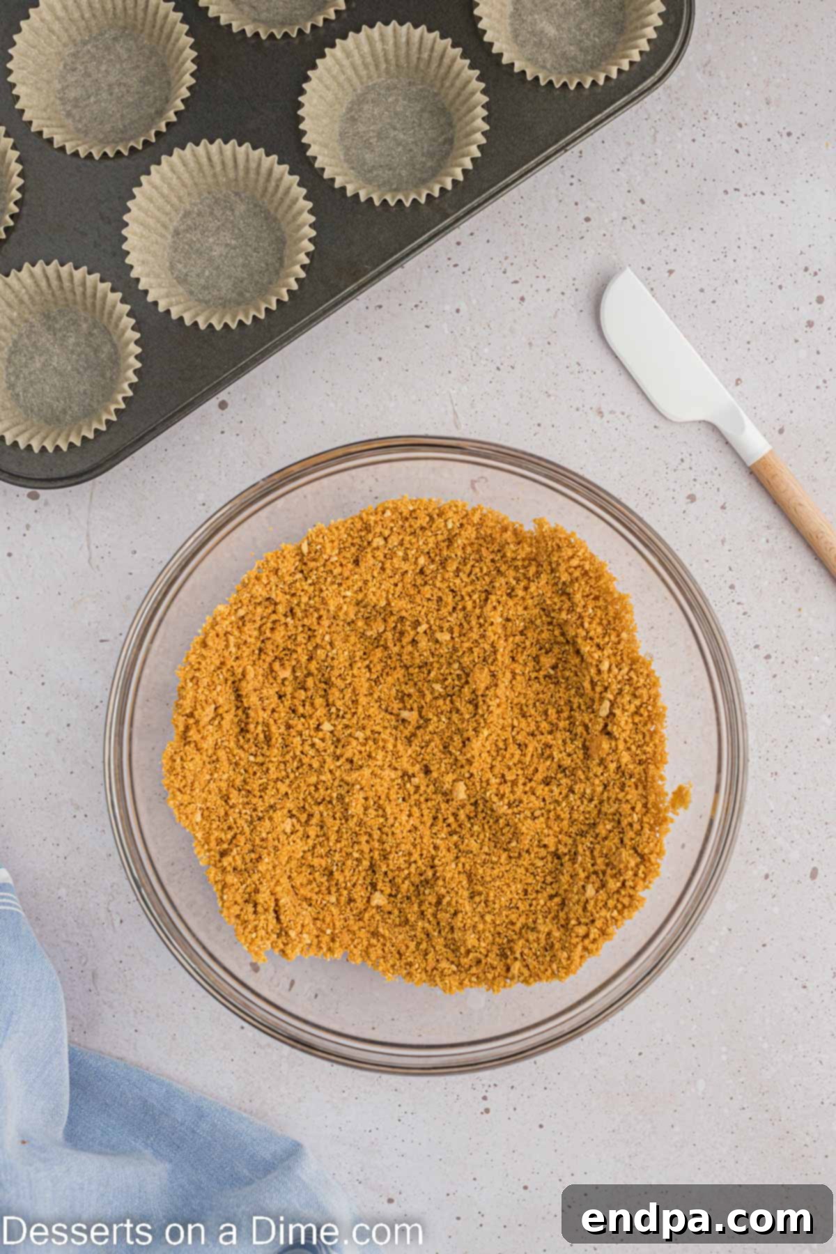 Hoppy Easter Cheesecake Bites 4 Bowl with graham cracker crumbs and melted butter, ready to be mixed for the cheesecake crust.