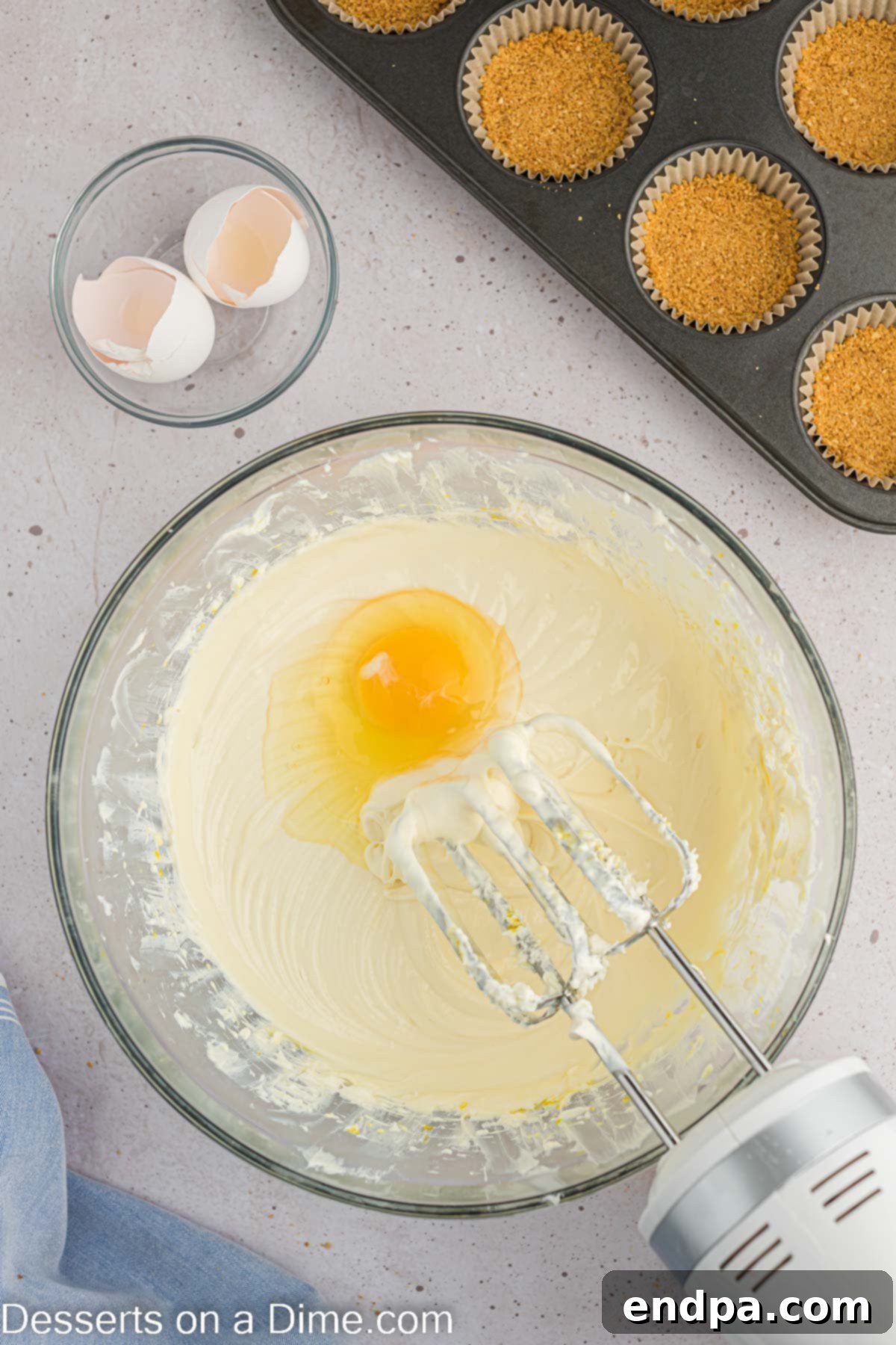 Hoppy Easter Cheesecake Bites 6 A mixing bowl with softened cream cheese, granulated sugar, and vanilla extract, ready to be beaten for the cheesecake filling.