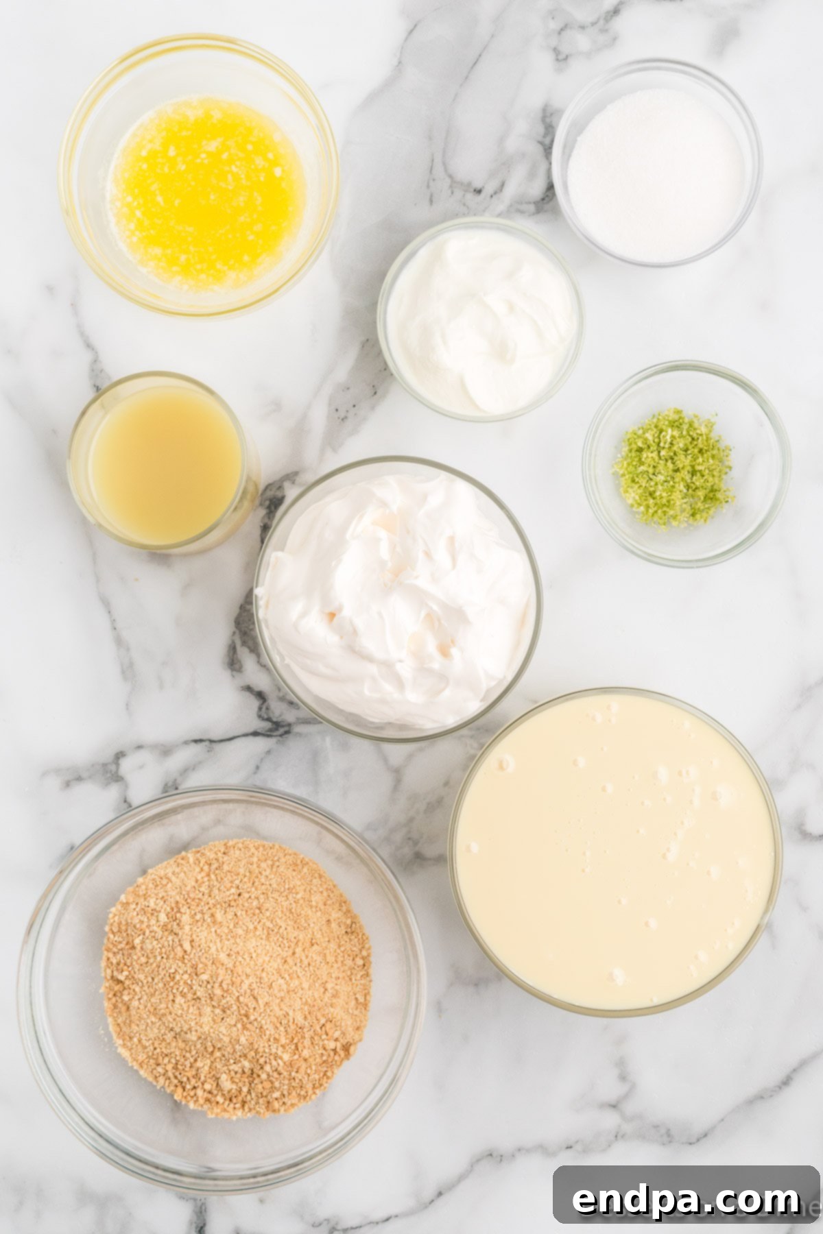 Foolproof Tangy Key Lime Pie 3 Ingredients for key lime pie - graham cracker crumbs, butter, sugar, sweetened condensed milk, sour cream, lime juice, whipped cream.