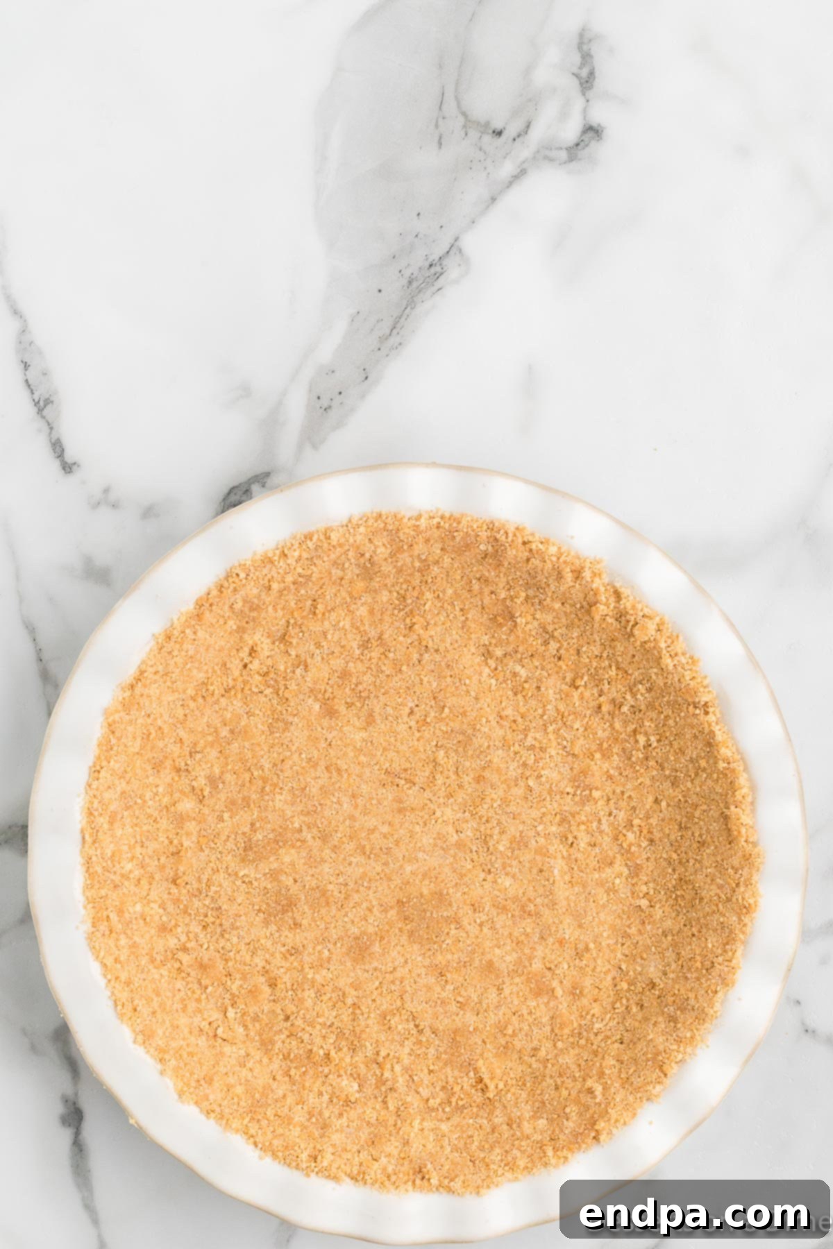 Foolproof Tangy Key Lime Pie 5 Crust ingredients pressed into a pie plate.