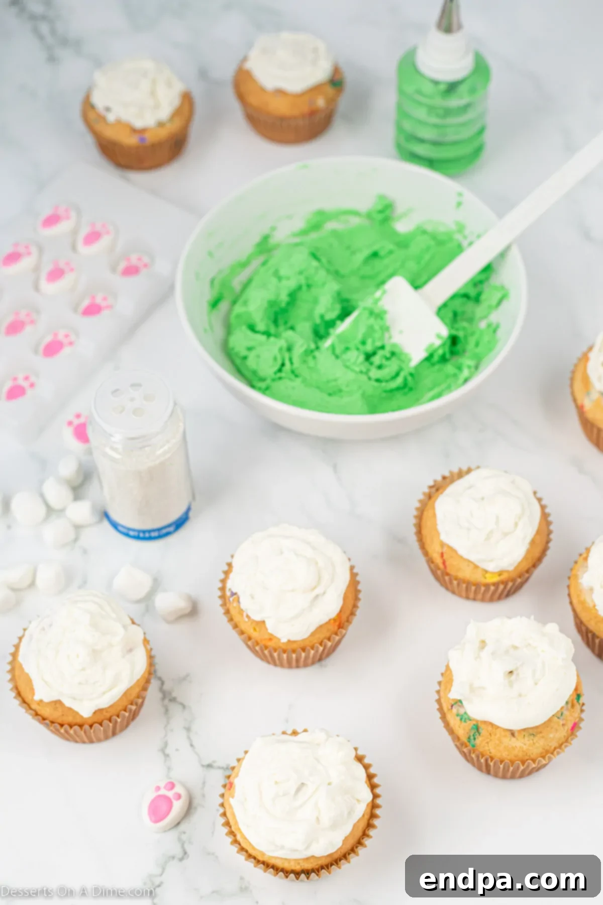 Cupcakes generously frosted with white buttercream.