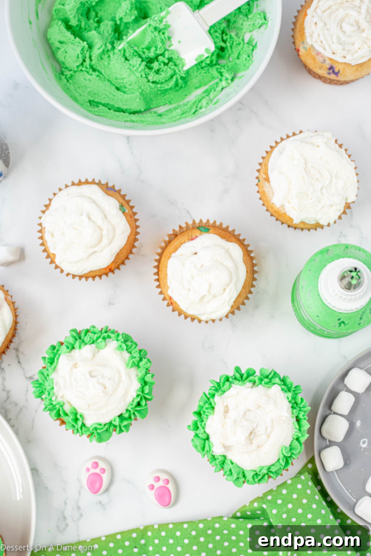 Green frosting piped around the white 'bunny butt' on a cupcake.