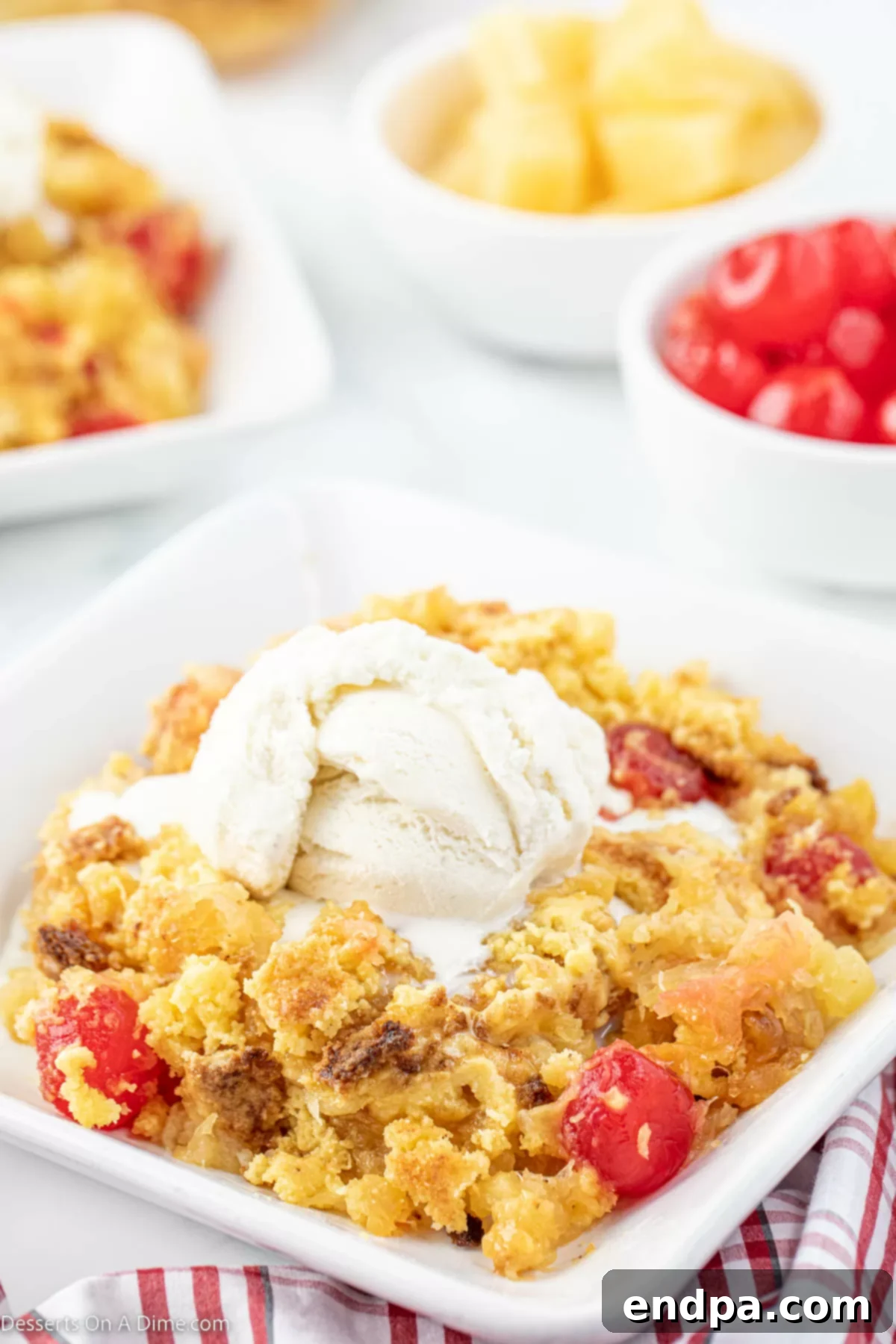 Effortless Pineapple Upside Down Delight 2 Pineapple upside down dump cake in a bowl with ice cream.