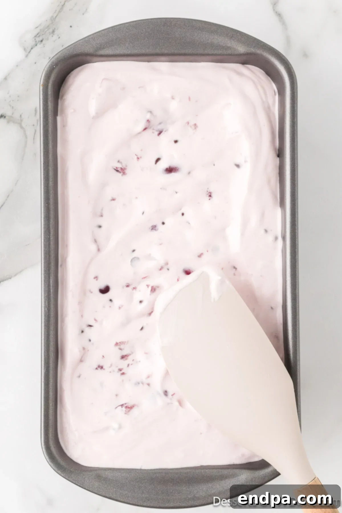 Dark Cherry Chocolate Dream Ice Cream 8 Ice cream mixture being spread evenly into a loaf pan.