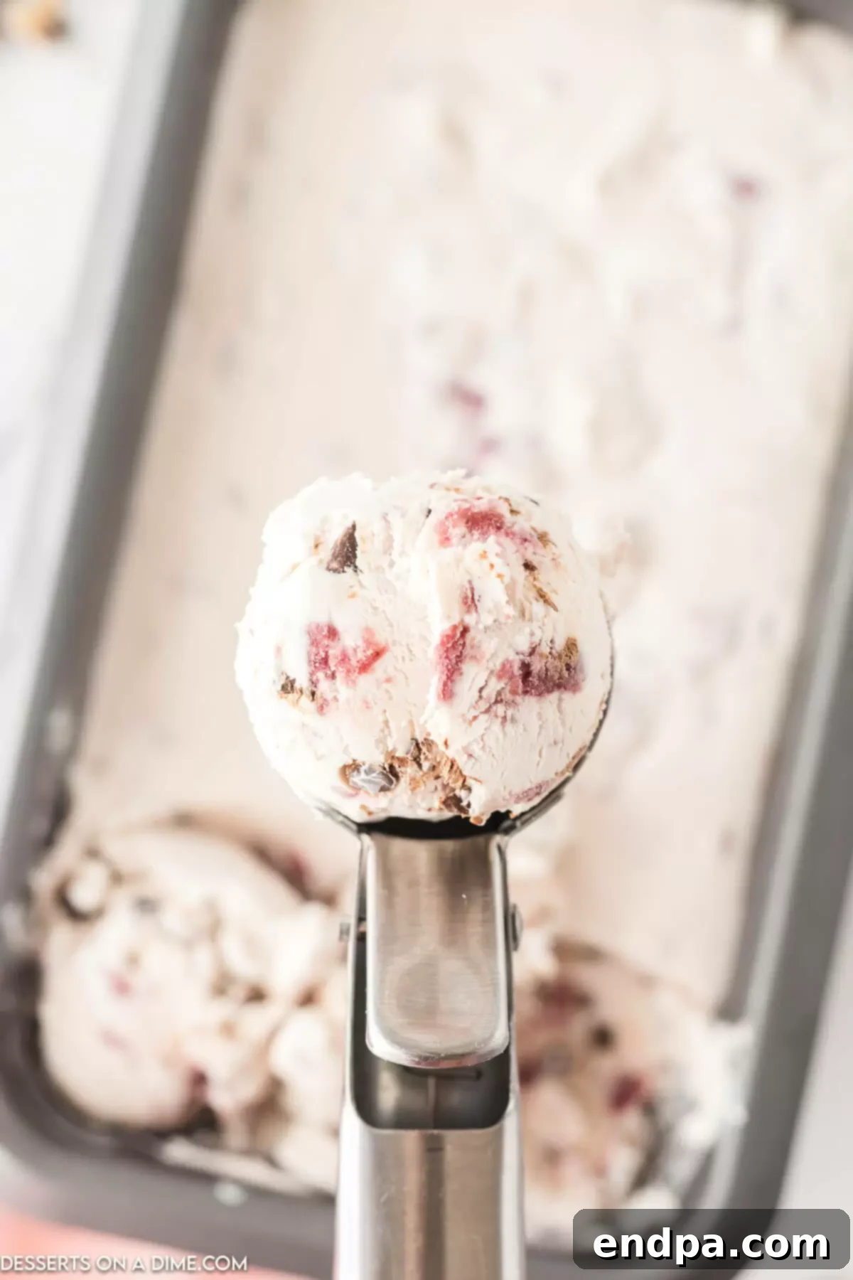 Dark Cherry Chocolate Dream Ice Cream 9 A loaf pan filled with frozen Cherry Chocolate Chip Ice Cream, ready to be scooped and enjoyed.