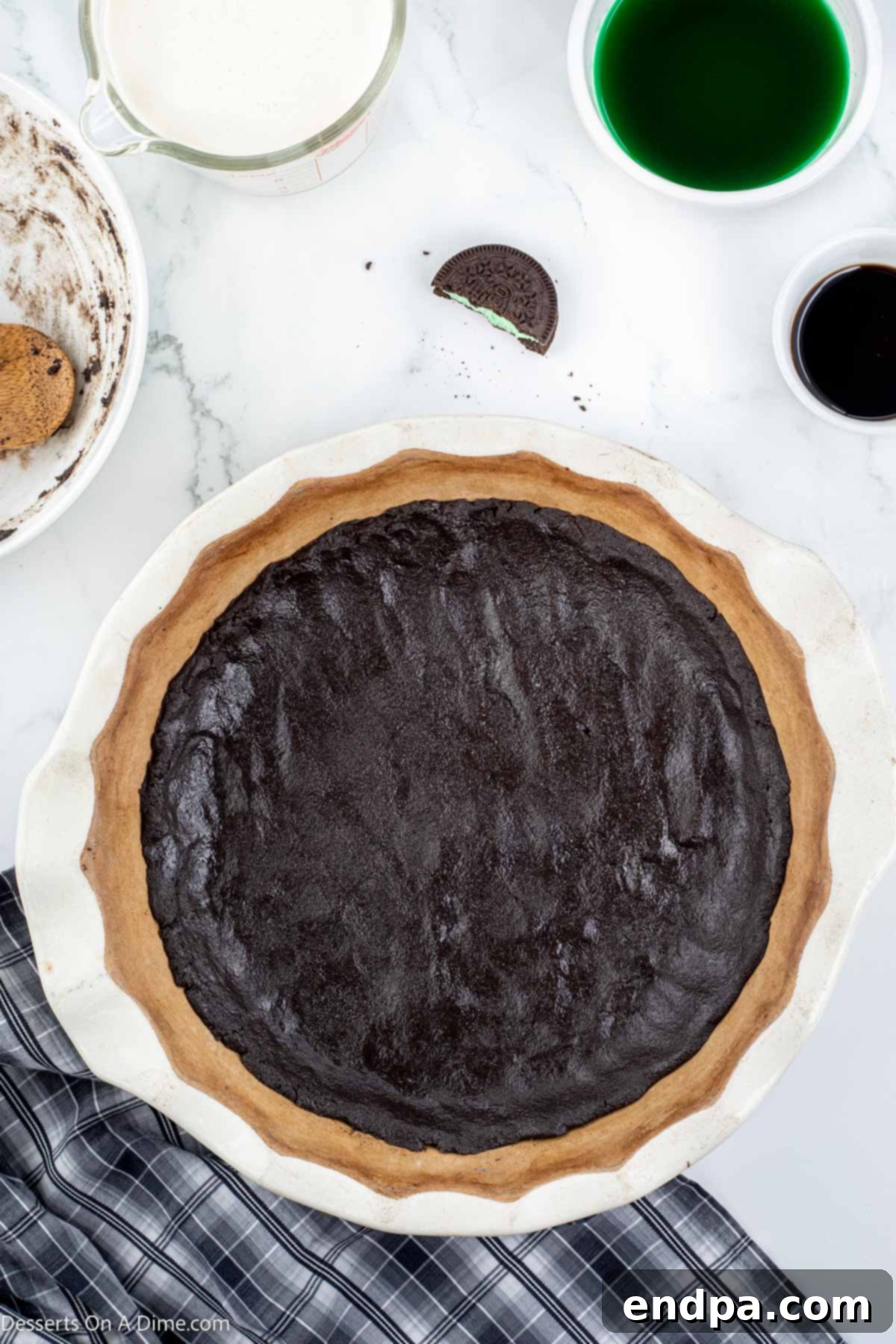 Emerald Mint Delight 5 Oreo cookie crumbs firmly pressed into the bottom and sides of a pie plate, forming the crust.