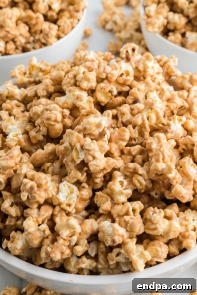A large bowl filled with freshly made Cookie Butter Popcorn, showcasing its golden-brown coating.