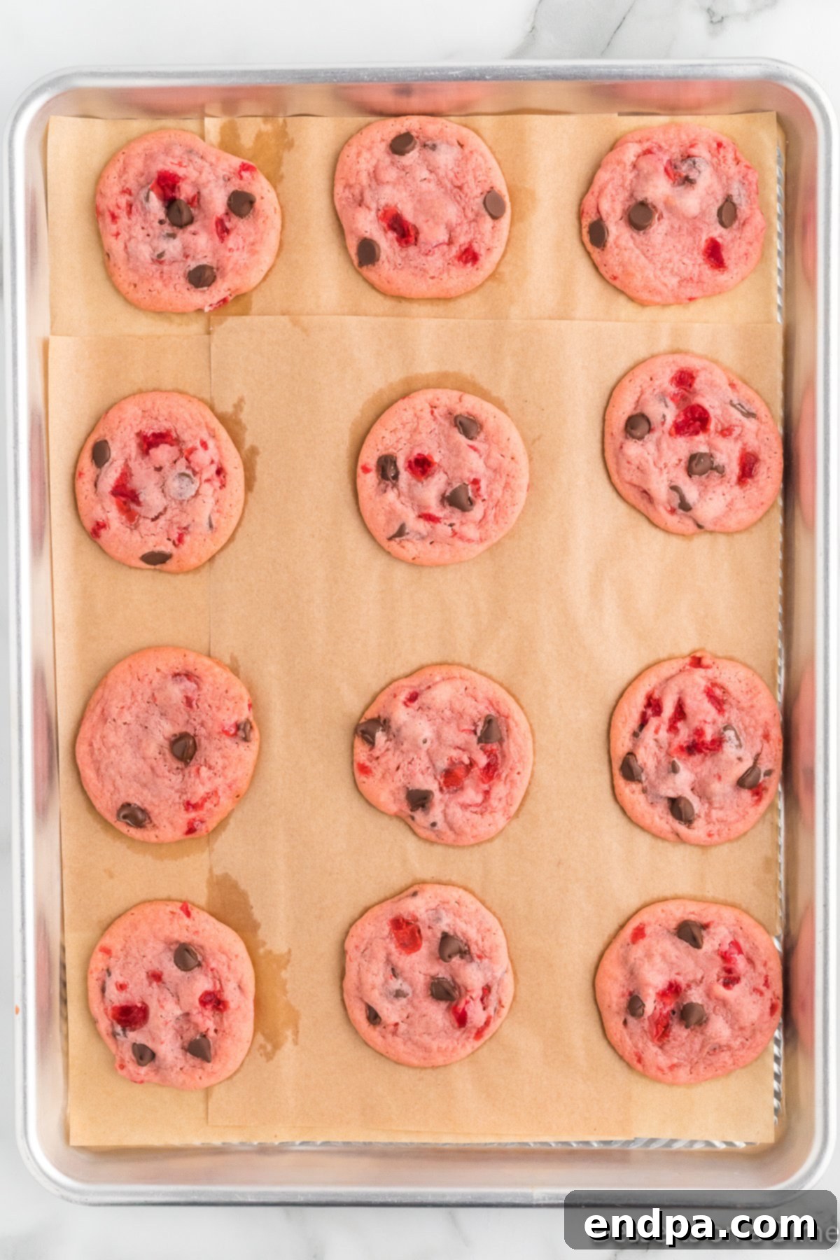 Cookies baked and cooling on baking sheet. 