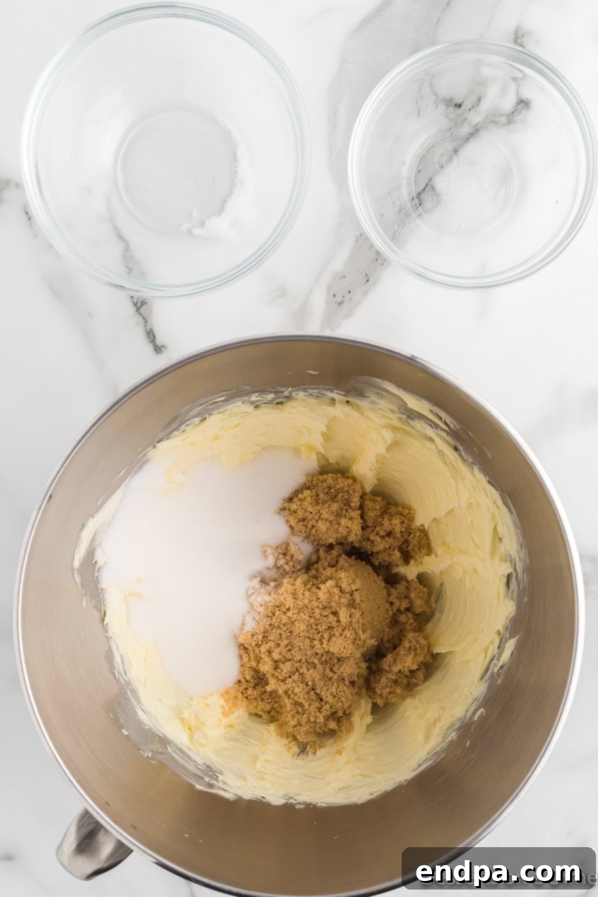 Butter and sugar combined in a bowl. 