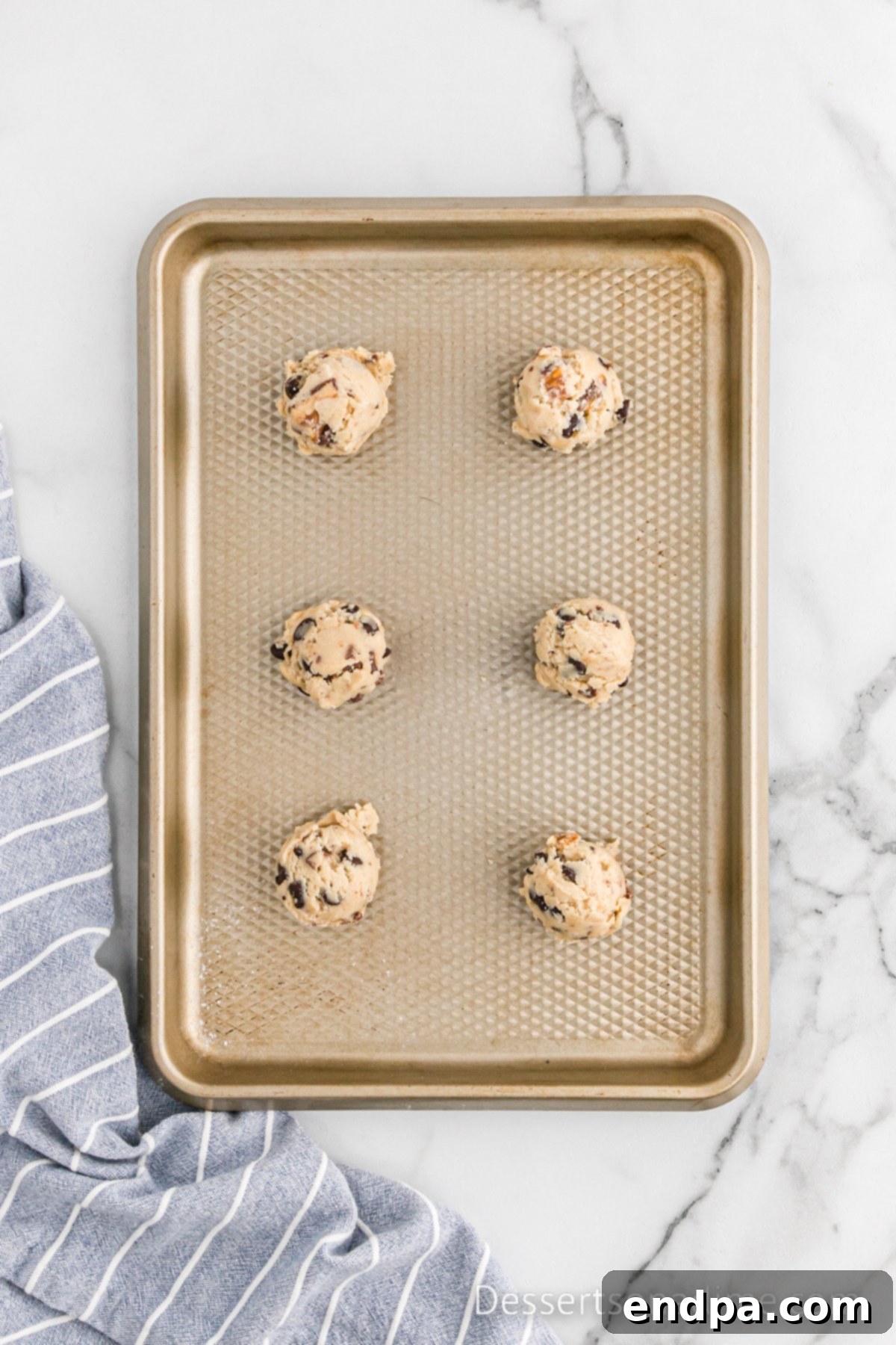 Ultimate Snickers Cookies 8 Cookie Dough scooped on baking sheet.
