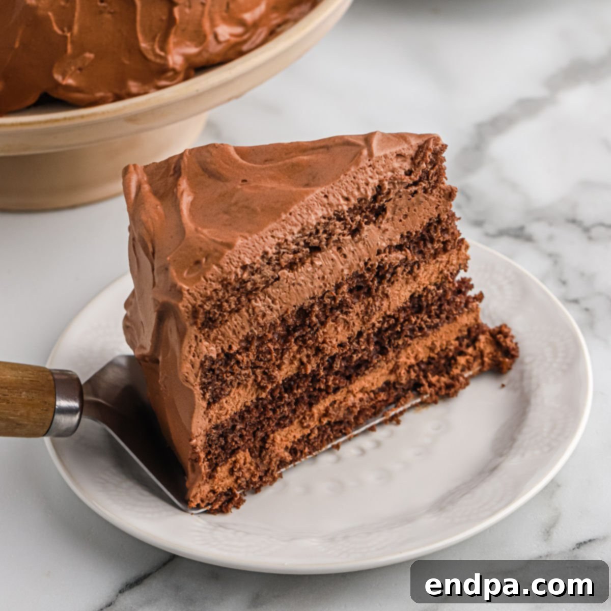 A beautifully decorated chocolate mousse cake ready to be served.