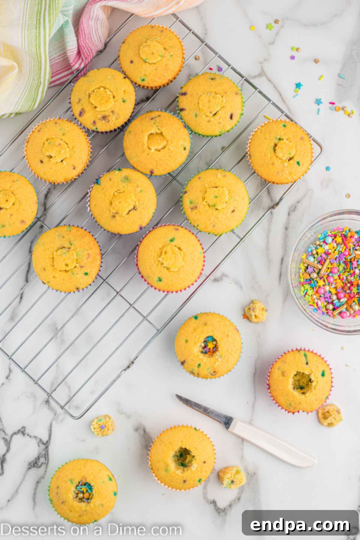 Confetti Cupcakes 5 Cupcakes with the centers cored out and filled with colorful sprinkles.