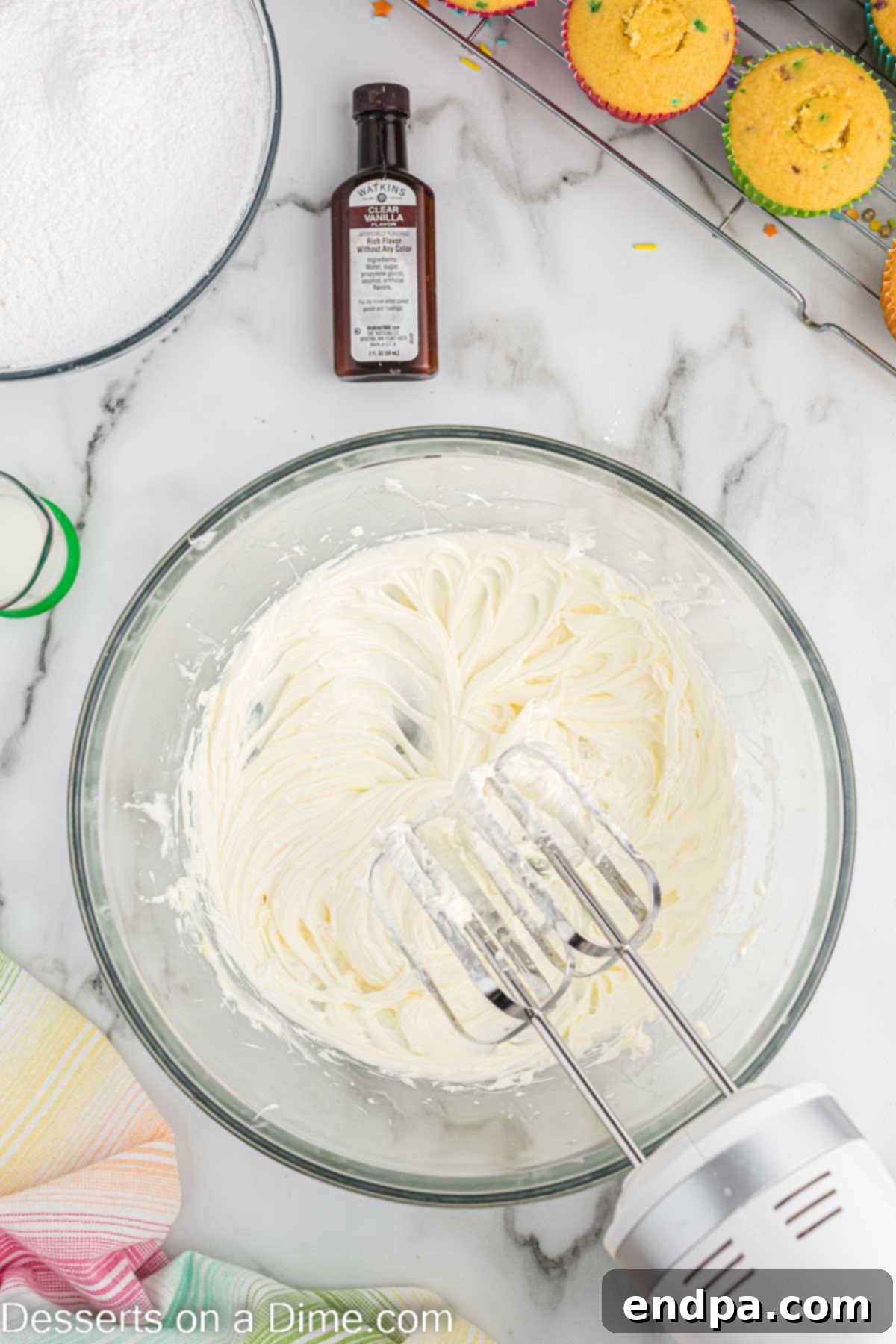 Confetti Cupcakes 6 Frosting ingredients being creamed together in a large mixing bowl.