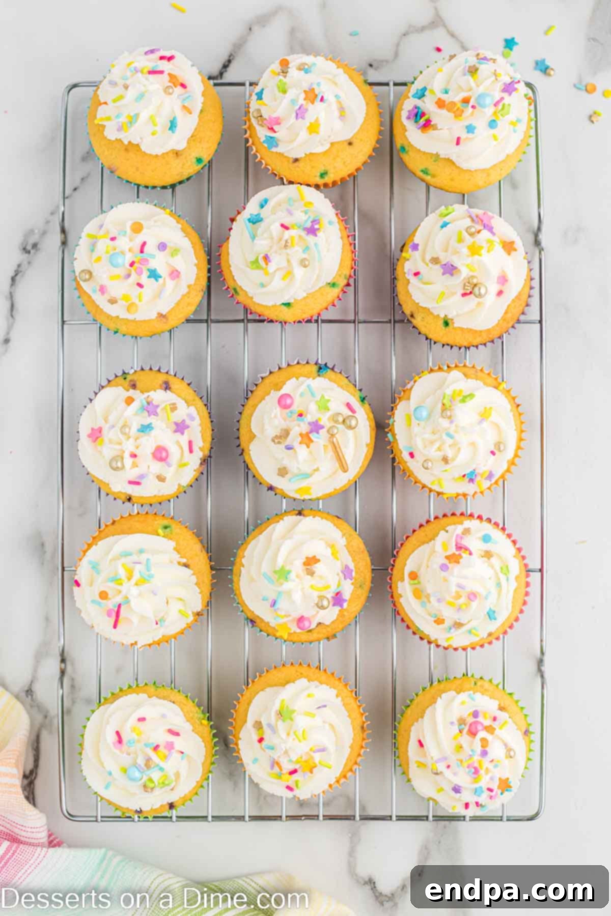 Confetti Cupcakes 9 Finished Pinata cupcakes with frosting piped and sprinkles on top.