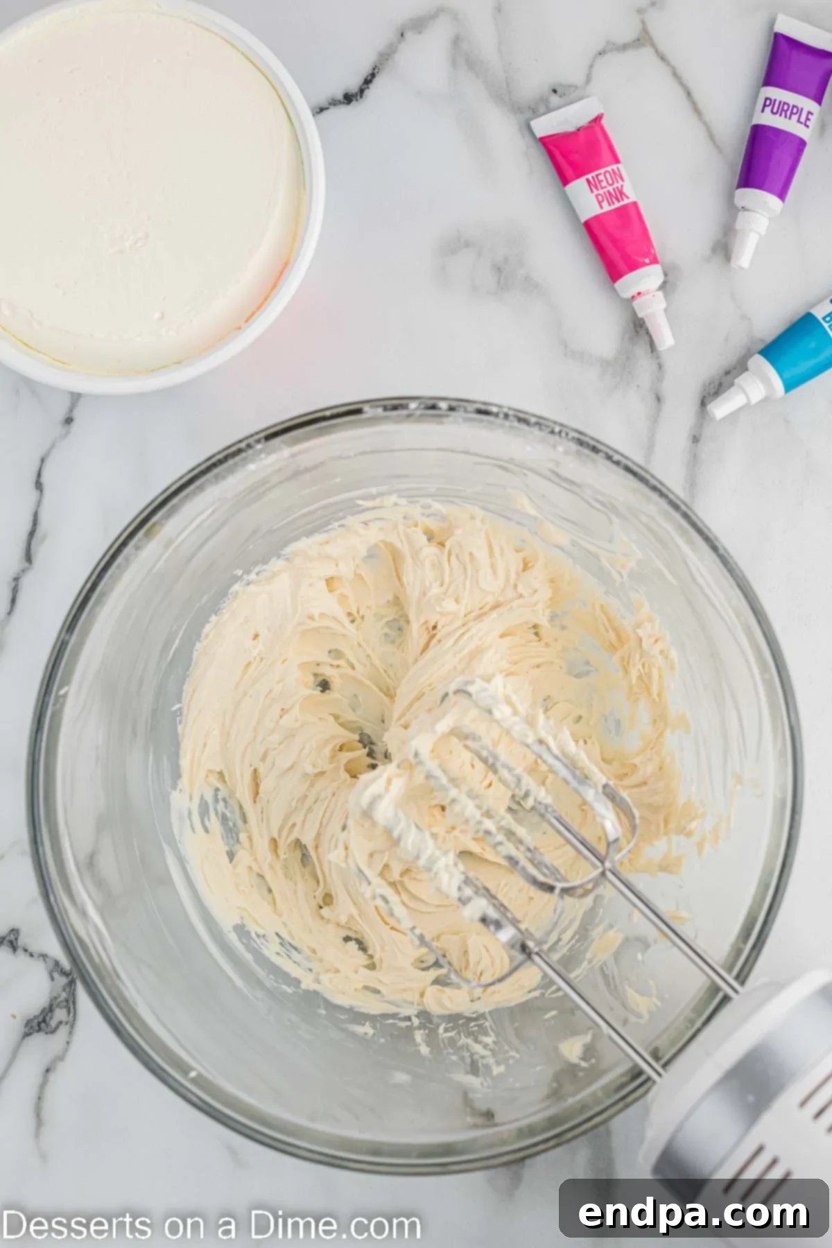 Cream cheese and powdered sugar combined in a bowl. 