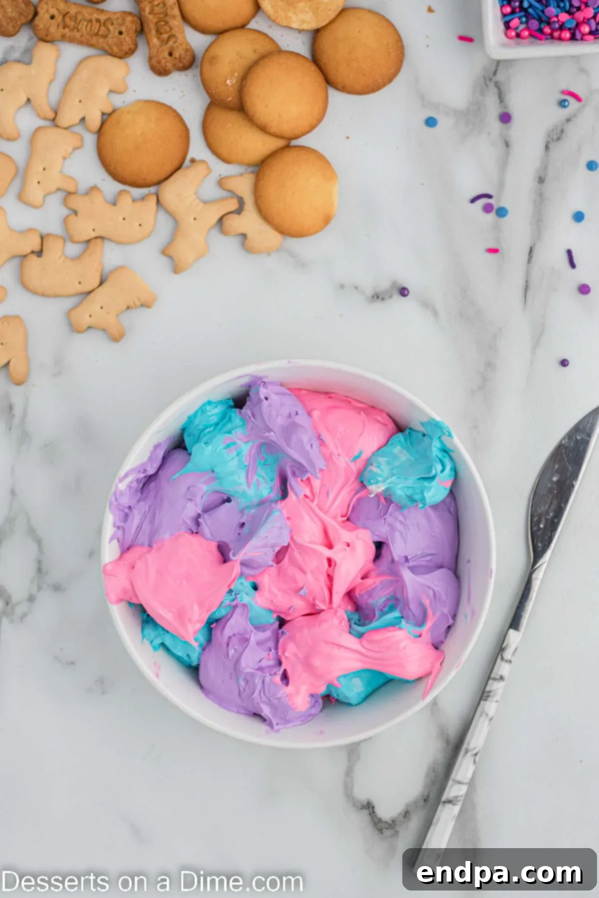 Each color of Unicorn Dip layered in a serving bowl. 