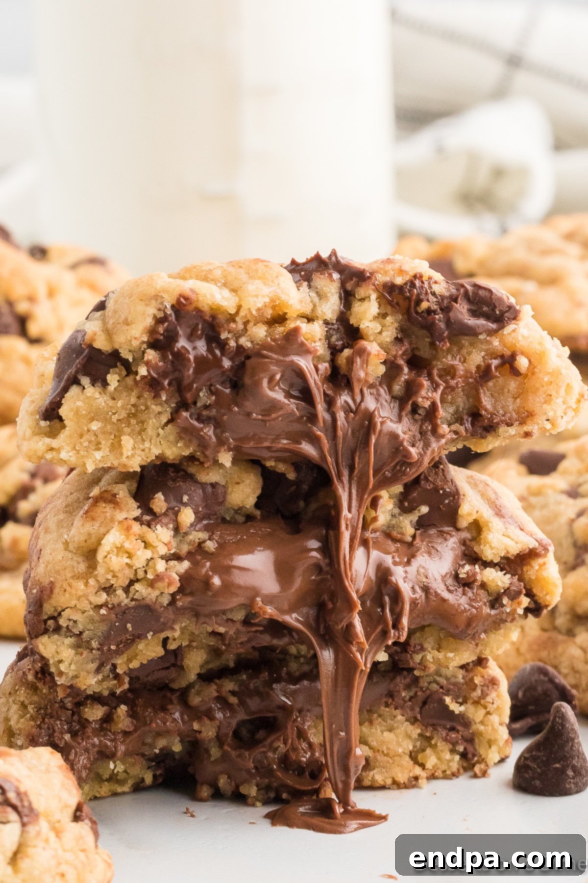 Ultimate Nutella Bomb Cookies 2 Nutella stuffed cookies with nutella coming out.