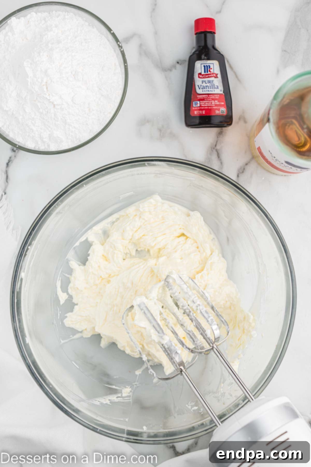 Softened butter and shortening being creamed together in a large mixing bowl.