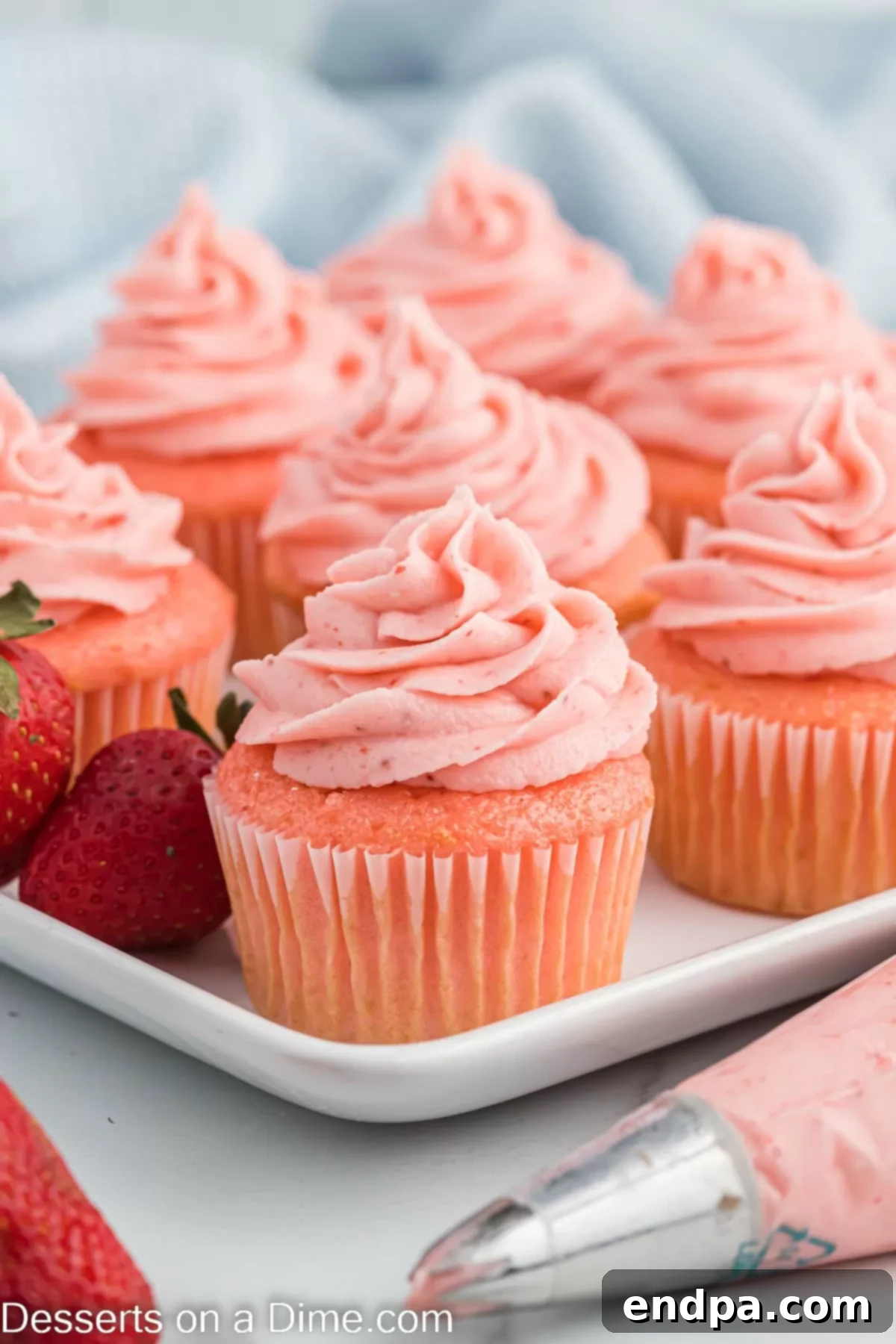 Luscious Strawberry Buttercream 2 Strawberry Cupcakes frosted with strawberry frosting on a platter