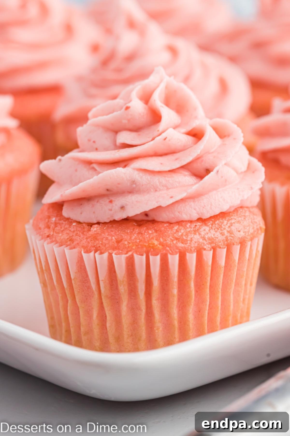 Luscious Strawberry Buttercream 8 Strawberry Cupcakes frosted with strawberry frosting on a platter