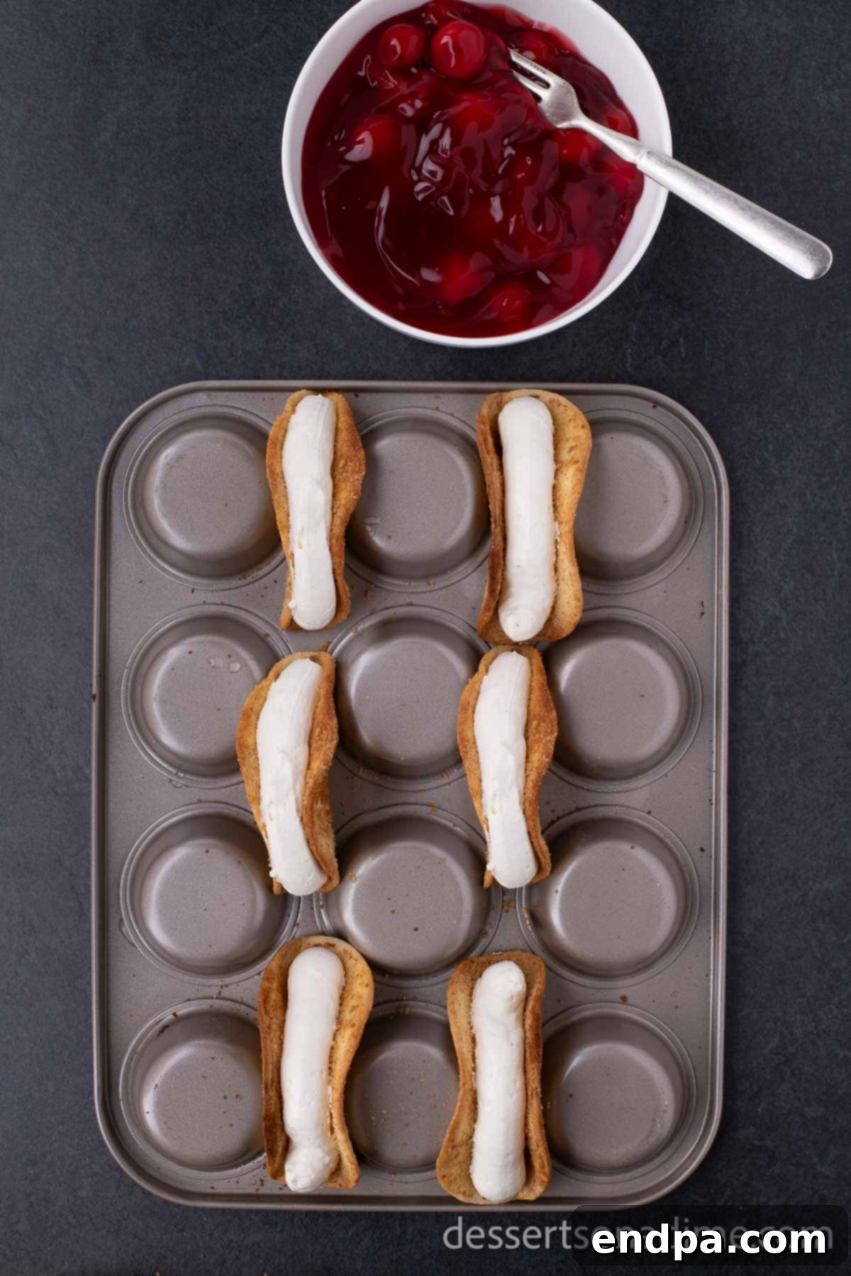 Heavenly Cherry Cheesecake Tacos 8 Piping the creamy cheesecake filling into the cooled taco shells.