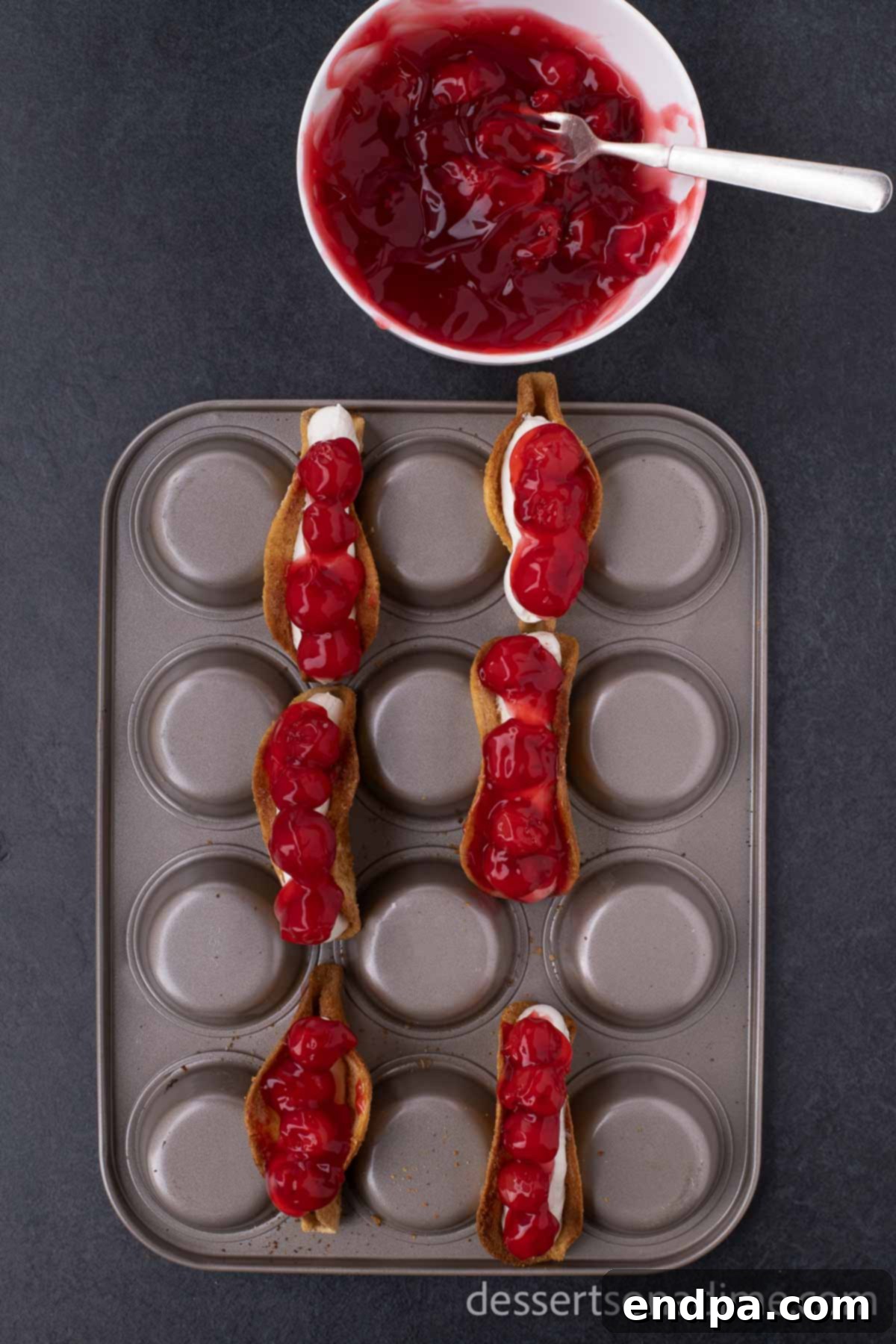 Heavenly Cherry Cheesecake Tacos 9 Adding cherry pie topping and fresh cherries to each filled cheesecake taco.