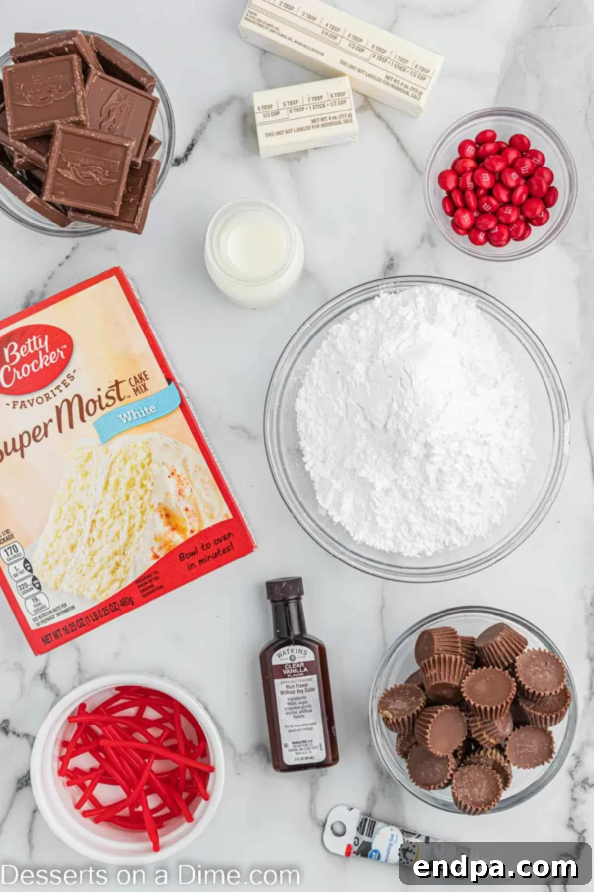 Ingredients needed - cake mix, mini peanut butter cups, chocolate square candies, M&M's, string licorice, brown decorating gel, butter, powdered sugar, milk, vanilla