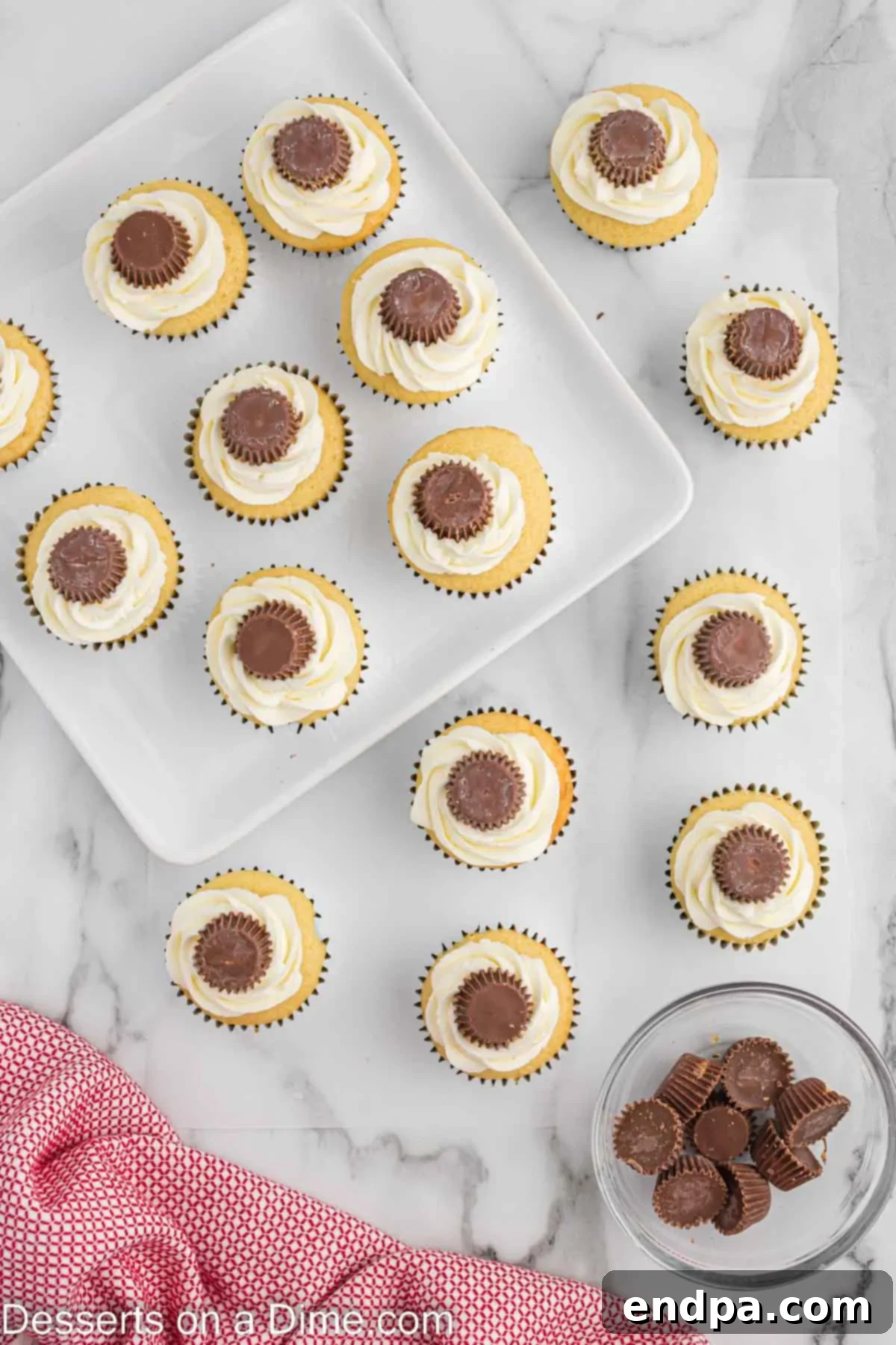 Mini Peanut Butter Cups upside down on each cupcake. 
