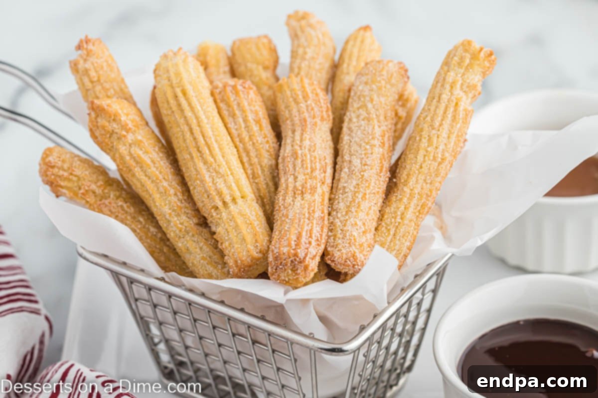 Crispy Air Fryer Churros in a basket, dusted with cinnamon sugar.
