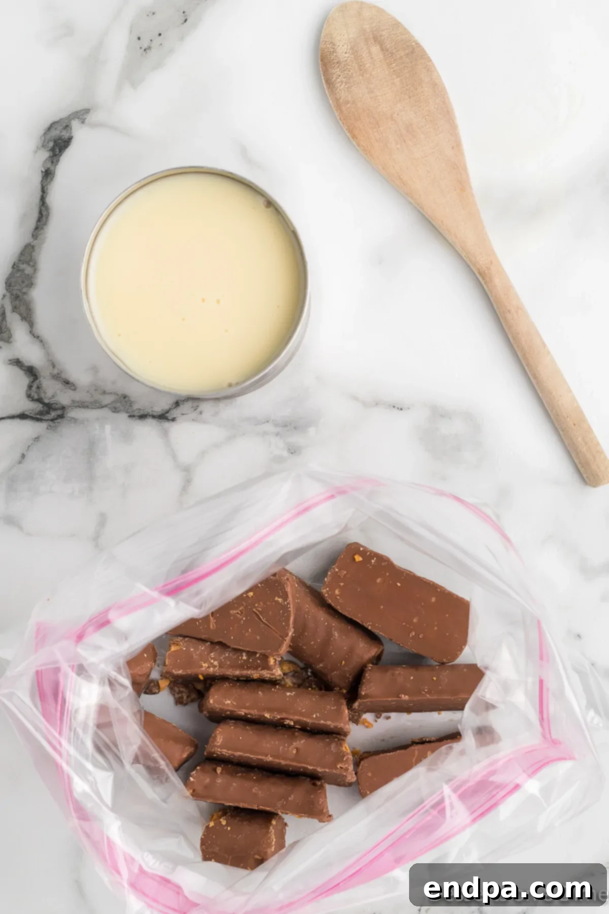 Homemade Butterfinger Crunch Ice Cream 4 Butterfinger candy bars sealed in a ziplock bag, ready for crushing.