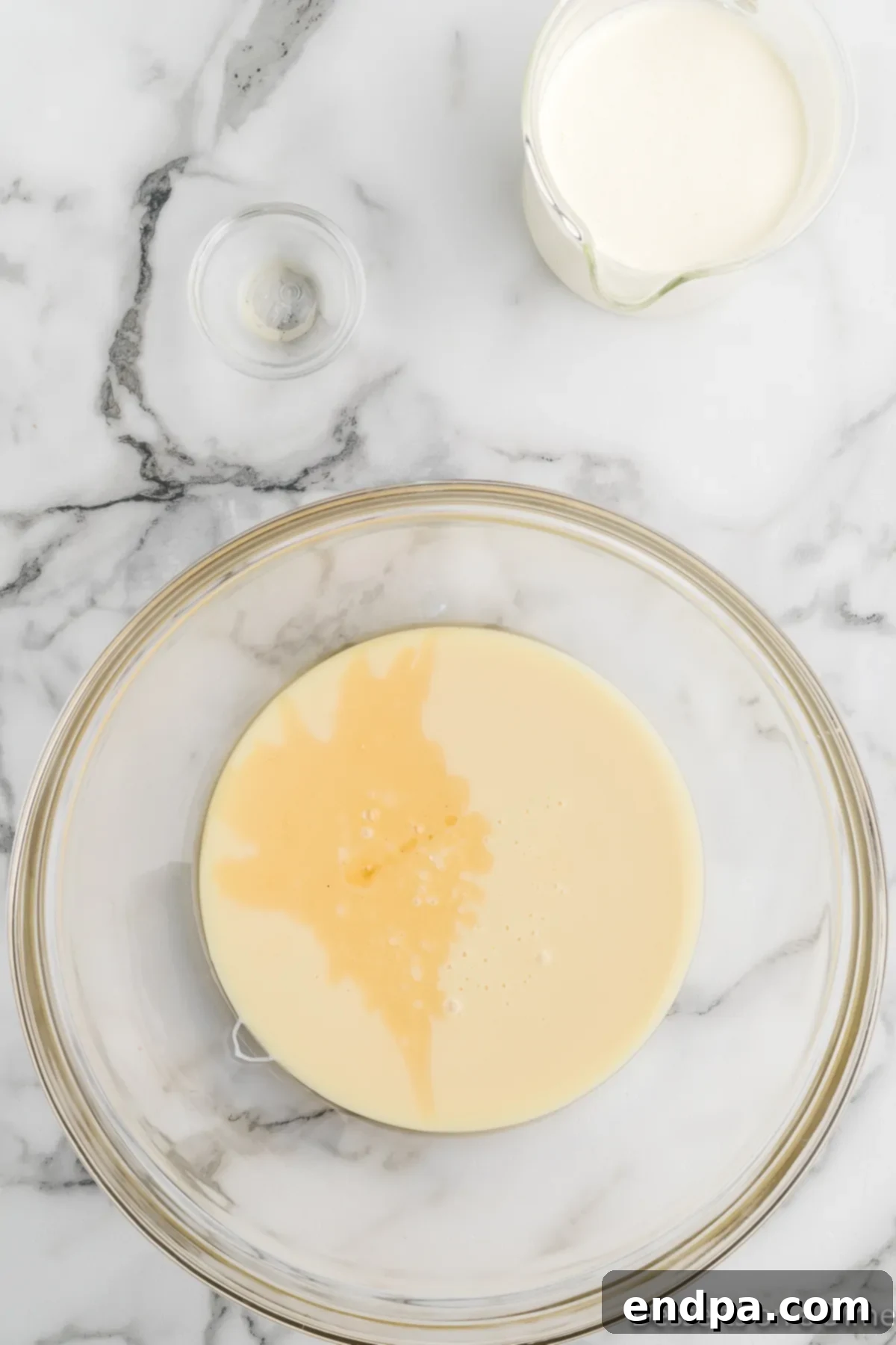 Homemade Butterfinger Crunch Ice Cream 5 Sweetened condensed milk and vanilla extract mixed in a large bowl.
