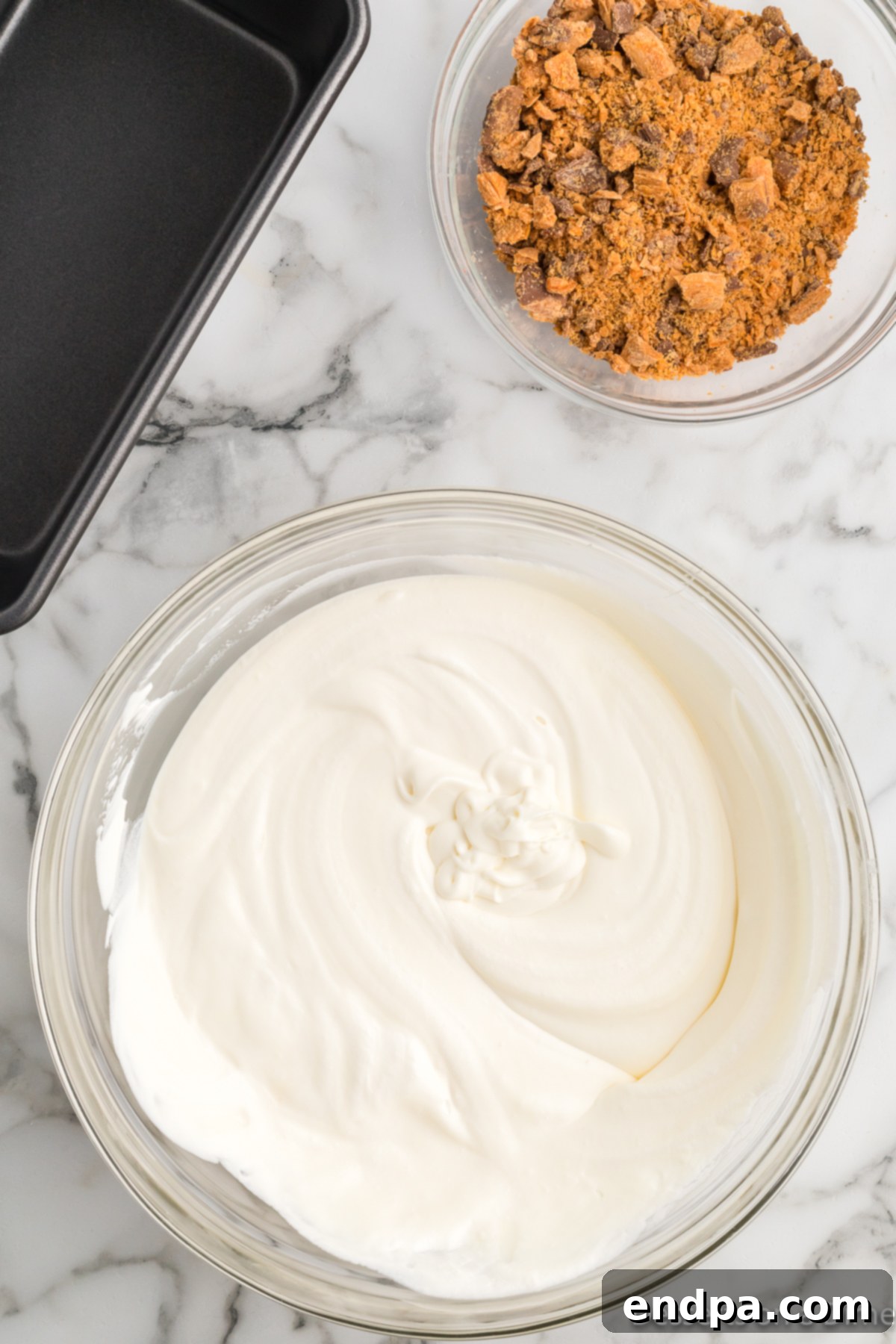 Homemade Butterfinger Crunch Ice Cream 7 Whipped cream gently folded into the sweetened condensed milk and vanilla mixture.